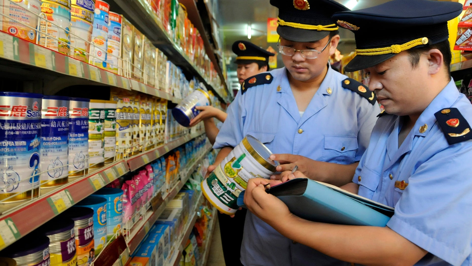 Local industry and commerce administrative bureau personnel check Sanlu formula milk products at a supermarket in Zaozhuang, Shandong province, September 12, 2008. China's Health Ministry has launched a nationwide investigation into the infant kidney stone case related with domestic milk powder, Sanlu formula, and asked all local health agencies to report relevant cases immediately, Xinhua News Agency reported. REUTERS/China Daily (CHINA). CHINA OUT. NO COMMERCIAL OR EDITORIAL SALES IN CHINA. - RTX8P0V