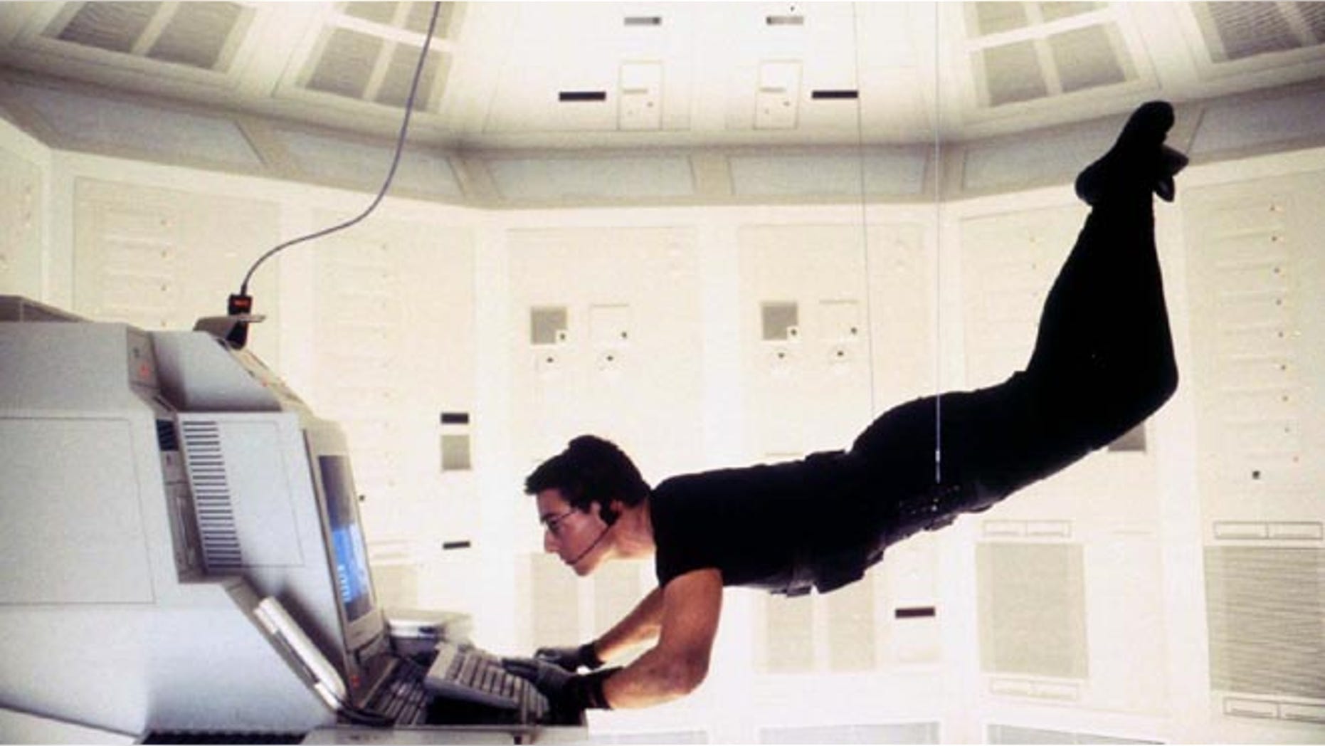 Actor Tom Cruise is shown as he portrays "Agent Ethan Hunt" in the adventure thriller film, "Mission Impossible."