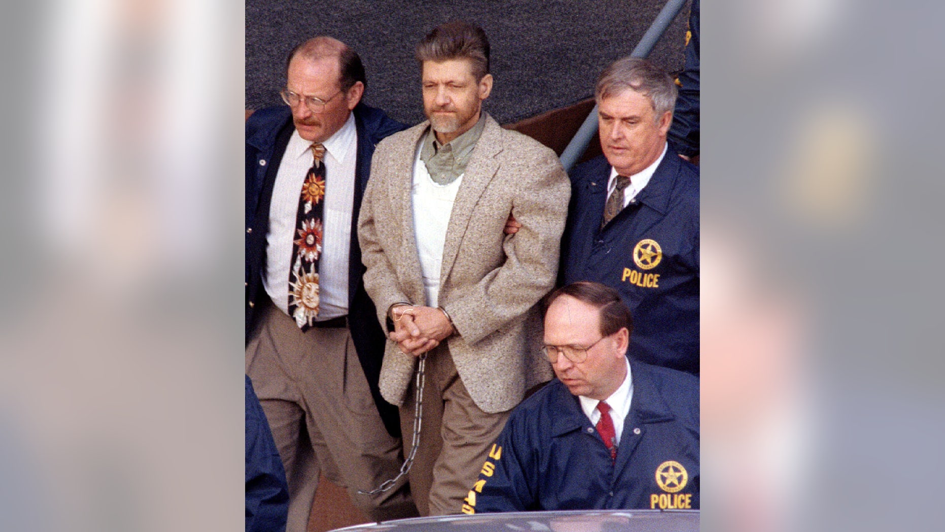 Unabomber suspect Ted Kaczynski is taken from the Helena federal courthouse by U.S. Marshals April 19. A federal judge denied Kaczynski's motion to dismiss the charges against him - RTXGTZC