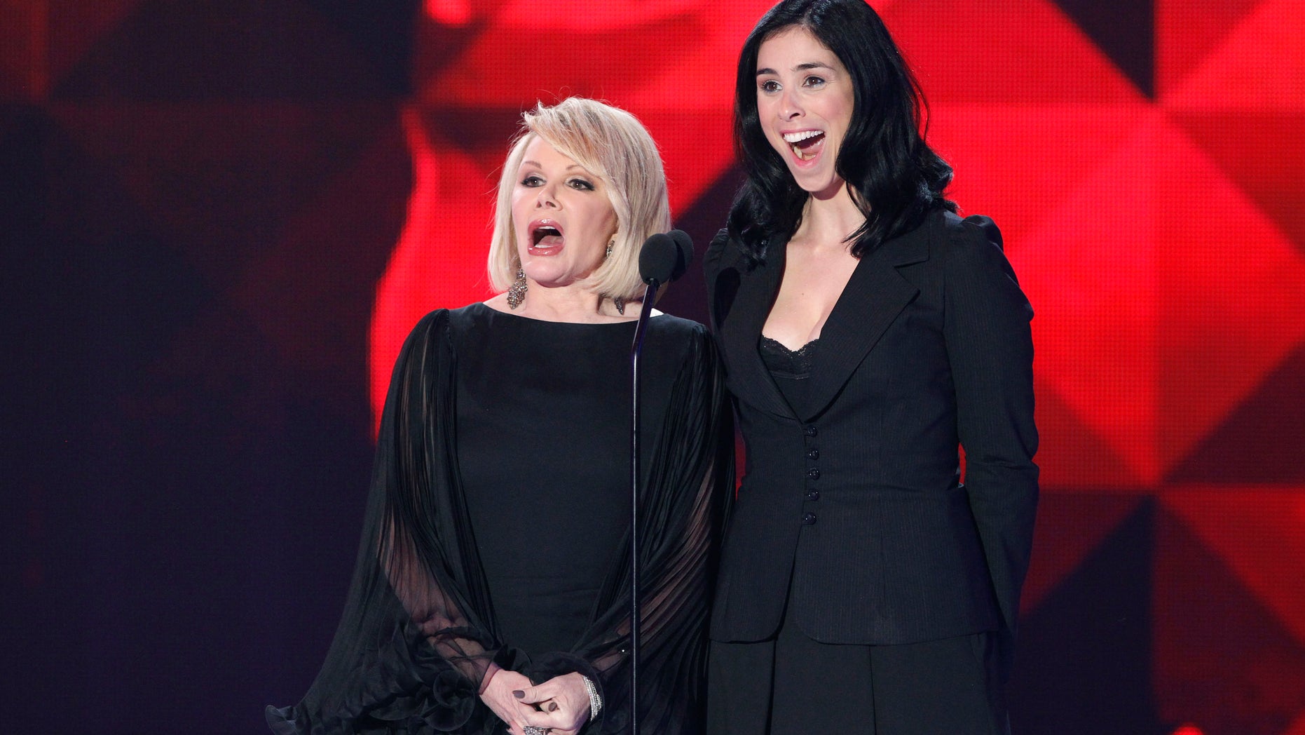 Joan Rivers (L) and Sarah Silverman speak on stage at the 16th Annual Critics' Choice Movie Awards in Hollywood, California January 14, 2011. REUTERS/Mario Anzuoni (UNITED STATES - Tags: ENTERTAINMENT) - RTXWL0Q