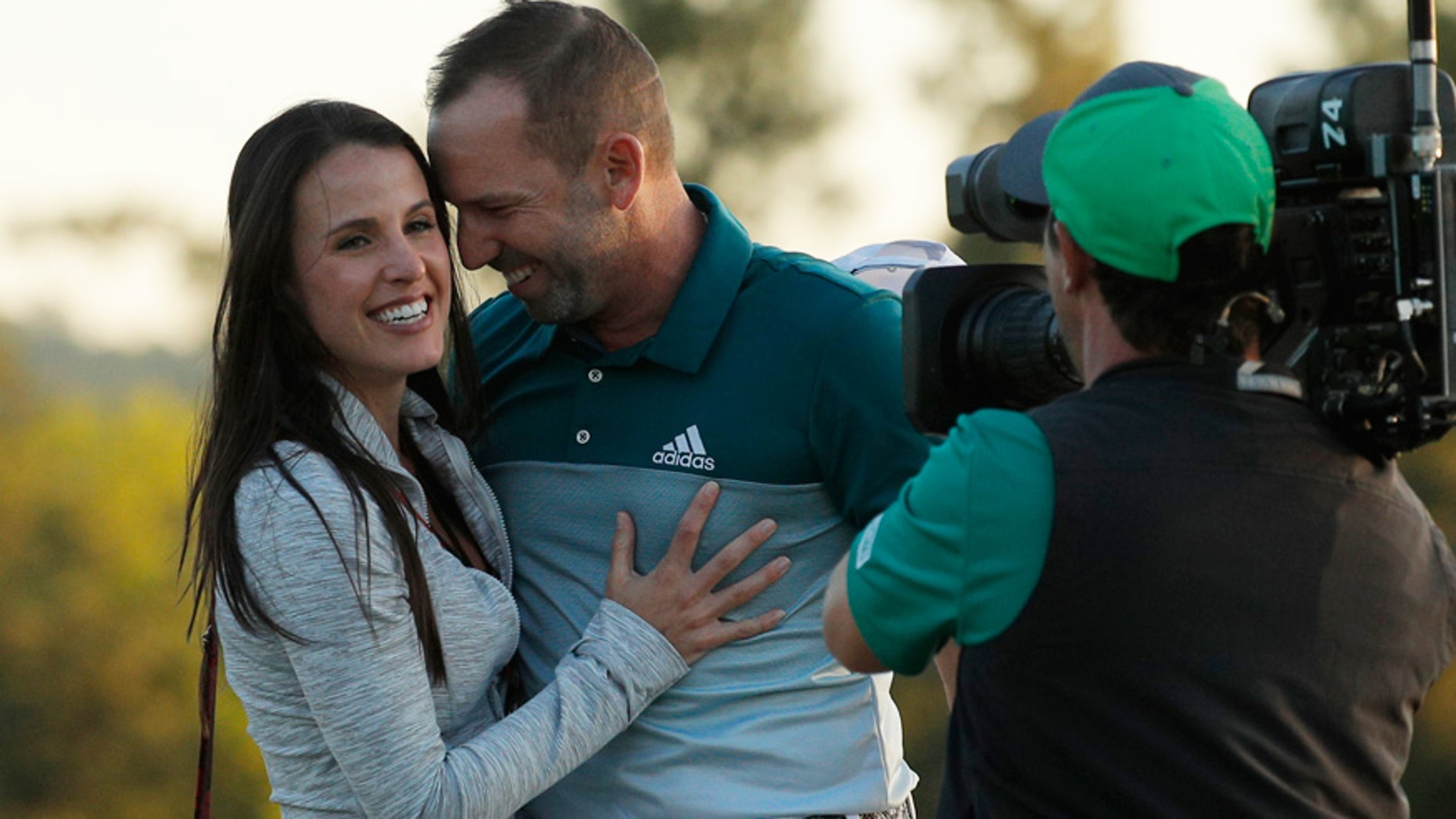 Sergio Garcia of Spain embraces Angela Akins after he won the 2017 Masters golf tournament in a playoff against Justin Rose of England at Augusta National Golf Club in Augusta, Georgia.