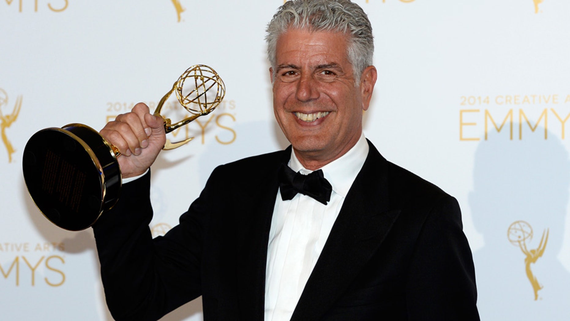 Anthony Bourdain poses backstage with the Emmy for Outstanding Informational Series "Anthony Bourdain: Parts Unknown" at the 2014 Creative Arts Emmy Awards in Los Angeles.