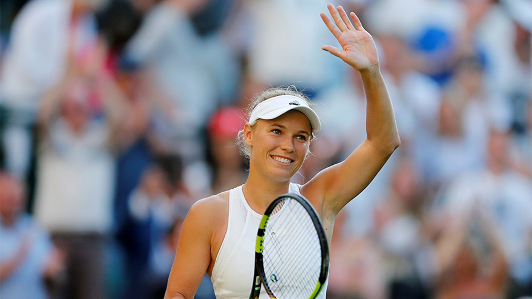 Denmark’s Caroline Wozniacki celebrates winning the first round match against Hungary’s Timea Babos.