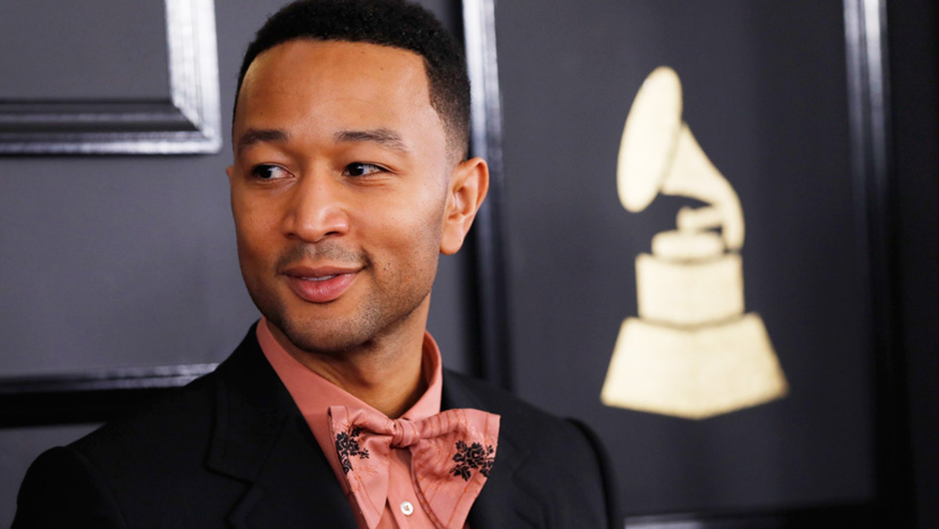 John Legend opens up about life under Trump presidency and fatherhood. Here Legend poses for photos at the Grammy Awards in Los Angeles.
