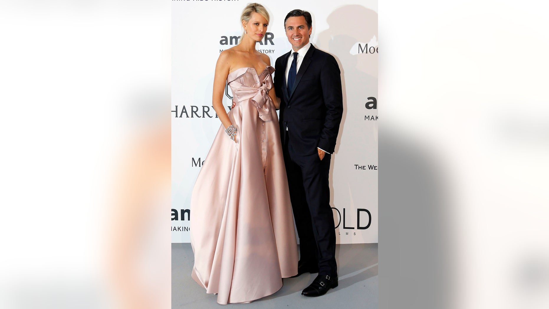 Model Karolina Kurkova (L) and her husband Archie Drury pose during a photocall as they arrive to attend the amfAR's Cinema Against AIDS 2015.