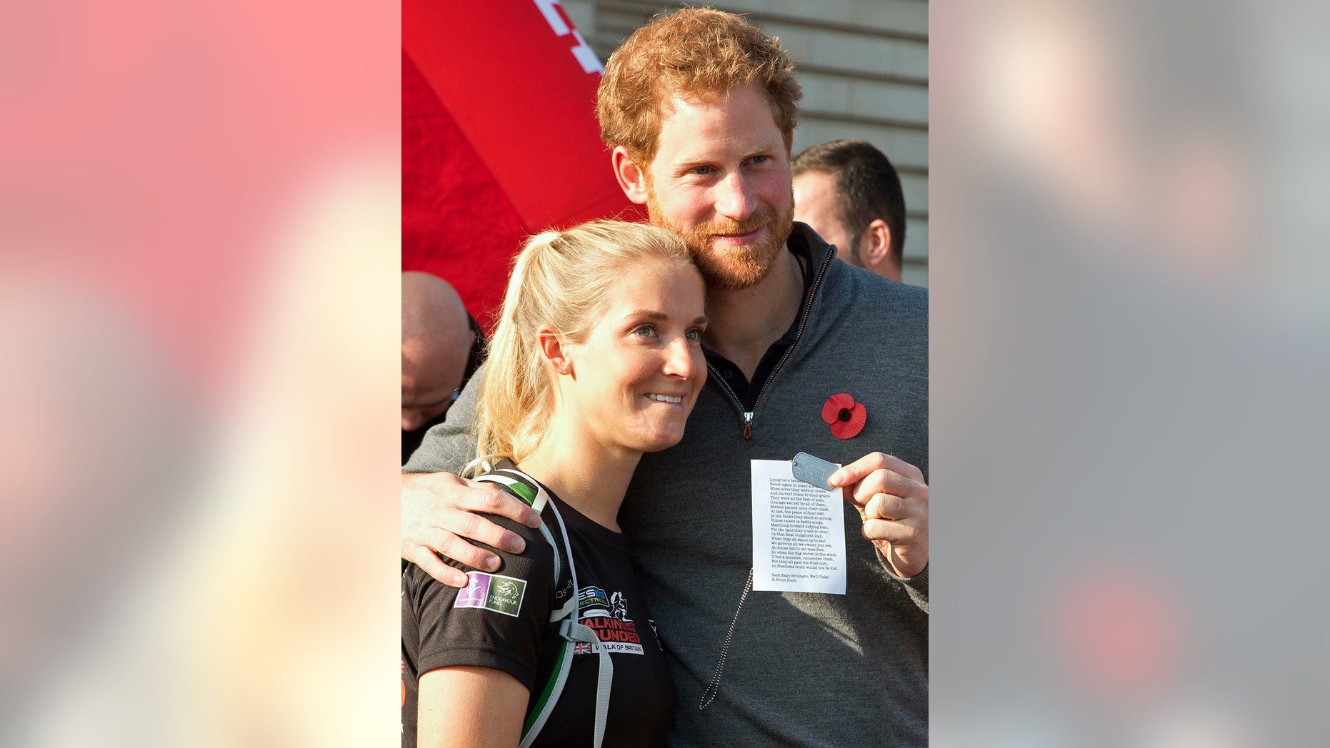 Britain's Prince Harry embraces Kirsty Ennis as he greets members of the Walking With The Wounded team as they arrive at Buckingham Palace in London, Britain November 1, 2015.