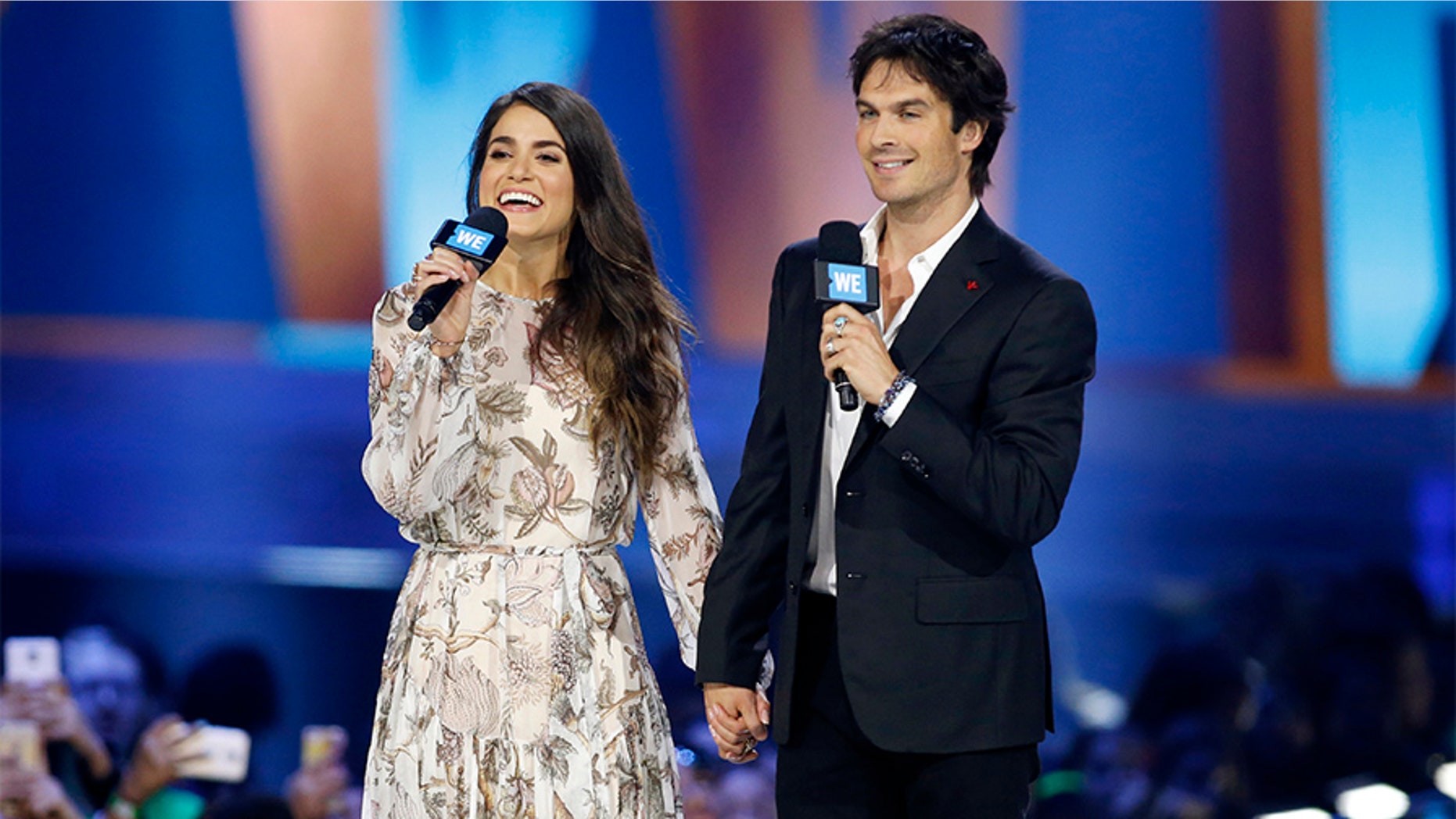Actors Nikki Reed and Ian Somerhalder speak on stage during We Day California in Inglewood, California, April 7, 2016. REUTERS/Danny Moloshok - D1AESXAUKVAA