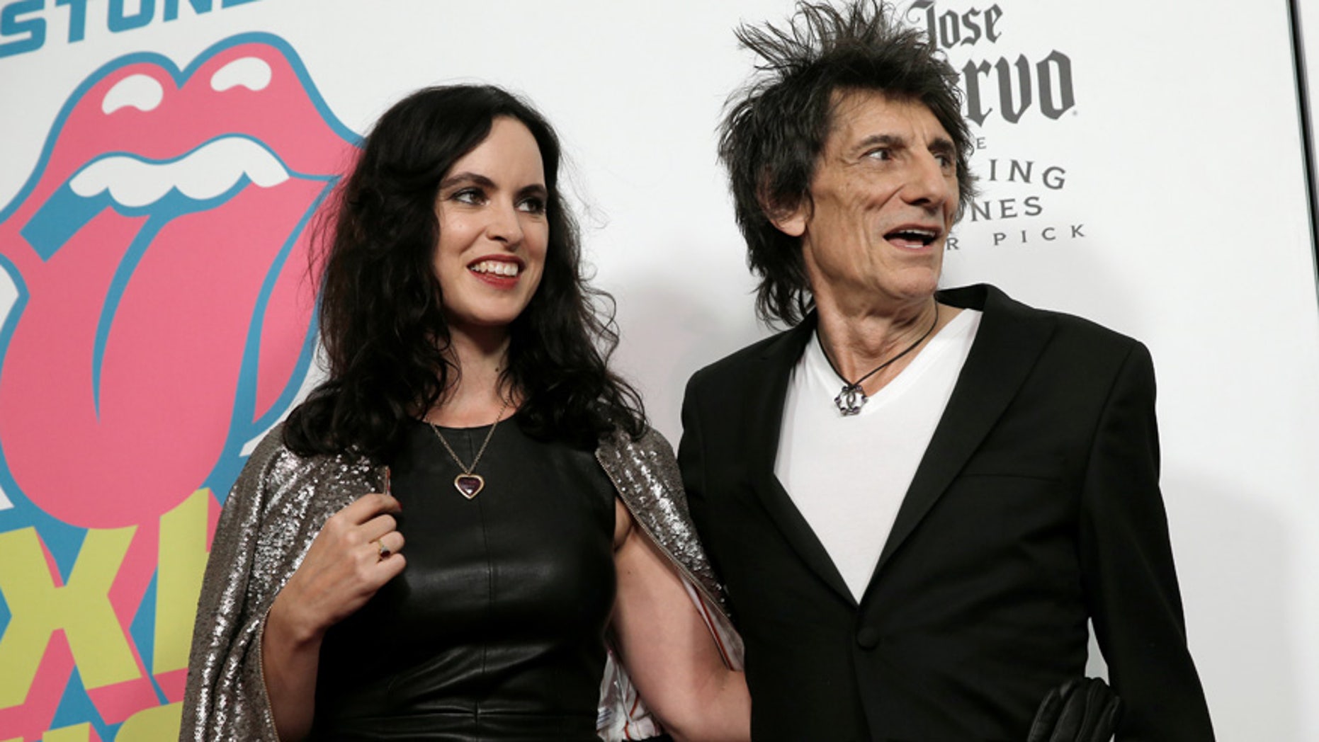 Rolling Stones member Ronnie Wood and his wife Sally Humphreys pose for photographers at the opening of the new exhibit "Exhibitionism: The Rolling Stones" in New York City on November 15, 2016.
