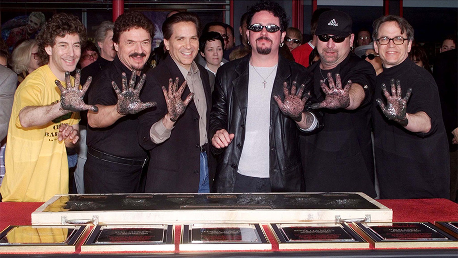 Members of the rock band Toto pose after placing their handprints in cement as they were inducted into Hollywood's RockWalk May 4 in Hollywood. The band, best know for songs such as "Rosanna" and "Hold The Line" were honored for their contributions to the rock n' roll artform. Shown (L-R) are Simon Phillips, Bobby Kimball, Mike Porcaro, Steve Lukather, David Paich and Steve Porcaro.
**DIGITAL IMAGE** - PBEAHULUKEG
