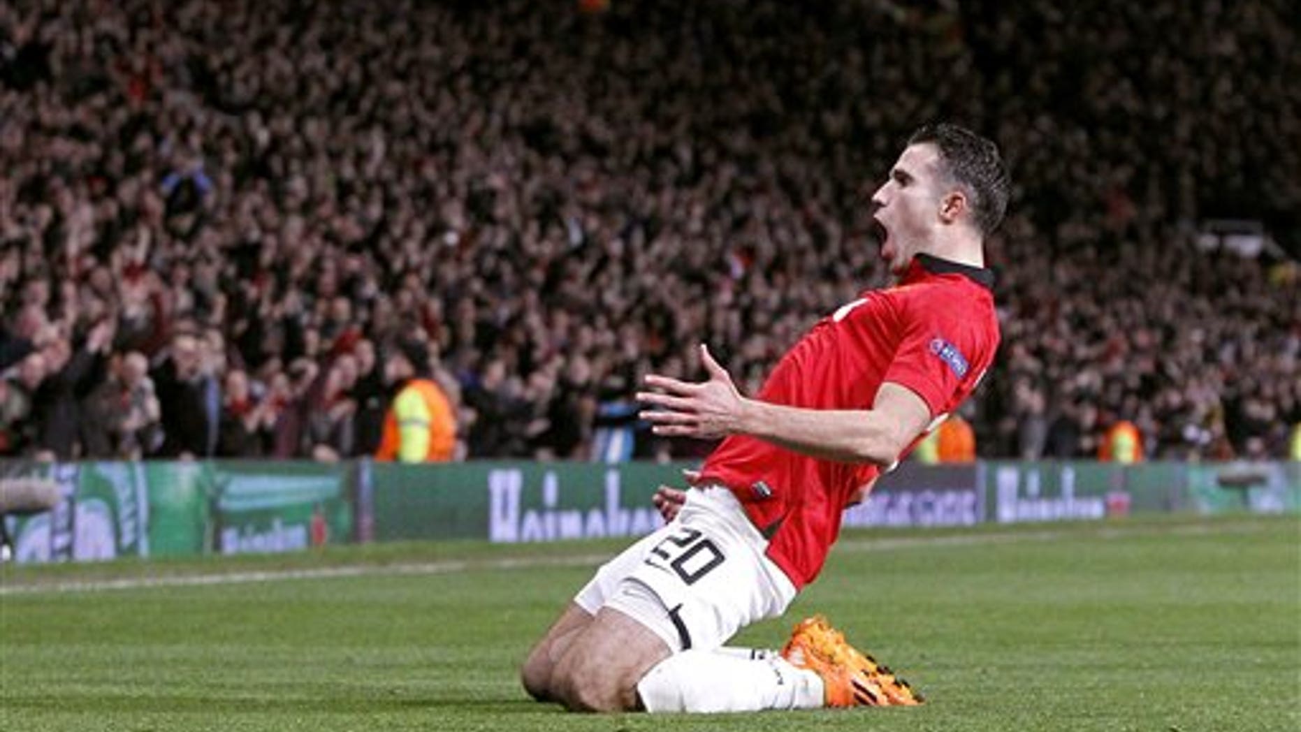 Manchester United's Robin van Persie celebrates scoring his side's third goal and his hat-trick, during the Champions League, Round of 16, second leg match against Olympiakos, at Old Trafford, Manchester, England, Wednesday March 19, 2014. (AP Photo /PA, Peter Byrne) UNITED KINGDOM OUT NO SALES NO ARCHIVE