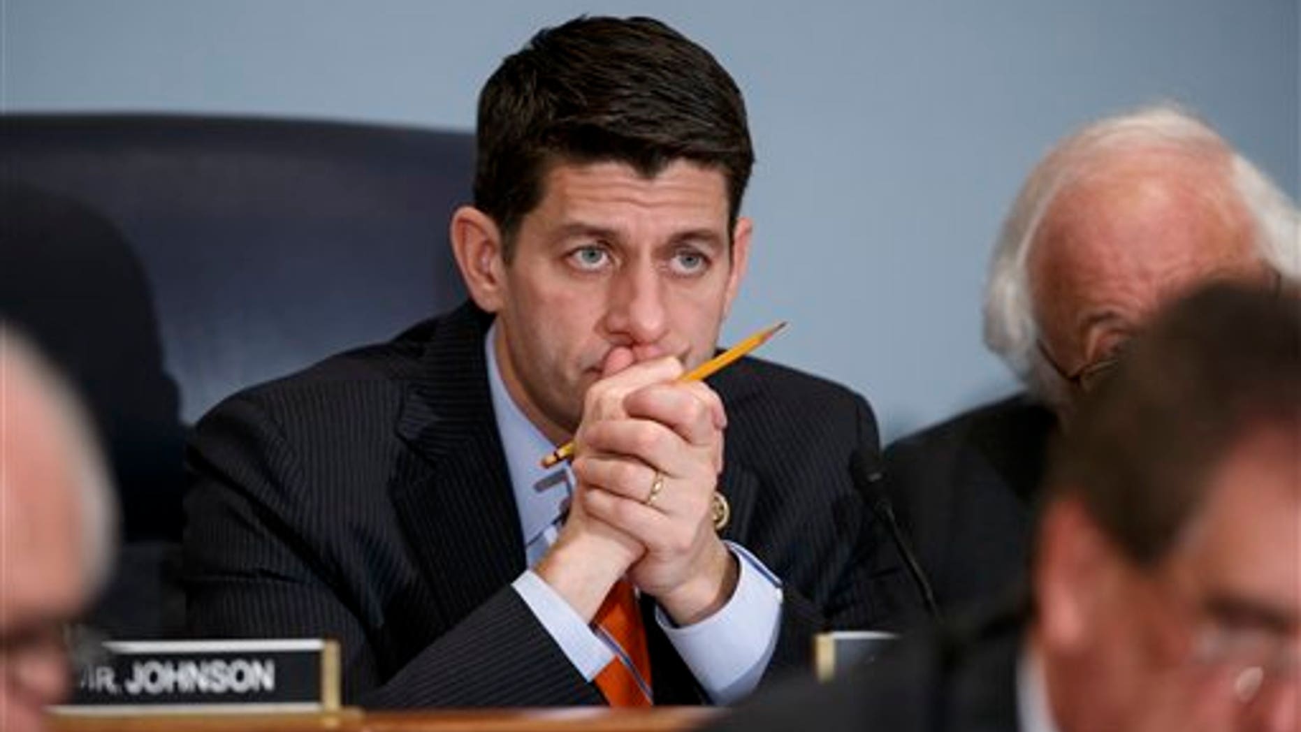 House Ways and Means Committee Chairman Paul Ryan, R-Wis., listens as Treasury Secretary Jack Lew defends President Obama's new budget proposals, on Capitol Hill in Washington, Tuesday, Feb. 3, 2015. (AP Photo/J. Scott Applewhite)