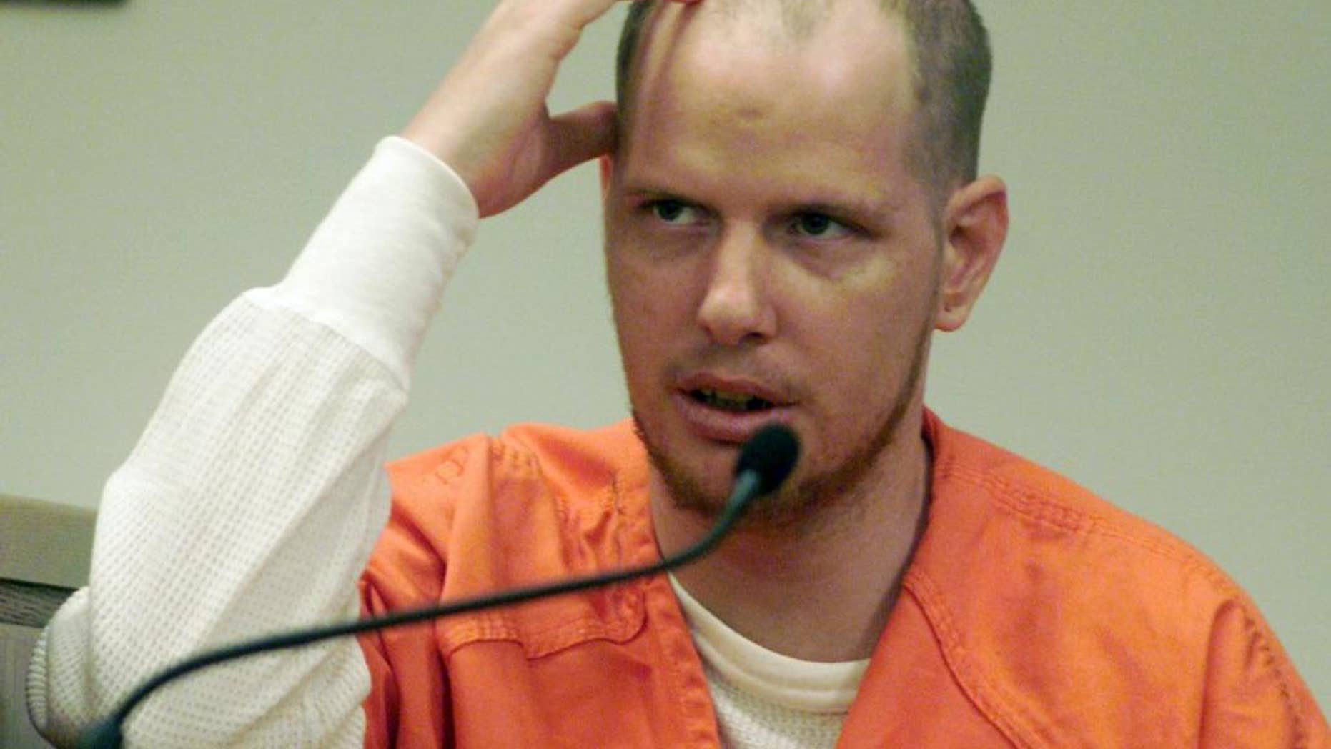 FILE - In this file photo of Oct. 25, 2001, Paul Michael Daniels testifies in Camden, N.J., using his hand to illustrate where he struck Carol Neulander, wife of New Jersey rabbi Fred Neulander, on the head with a lead pipe. Daniels, a confessed hit man who was one of two people paid to kill the rabbi's wife in 1994 on orders from her husband, is scheduled to be released from prison one day before the 20th anniversary of the victim's death. Neulander was convicted of murder and is serving a life sentence in prison. (AP Photo/Camden Courier-Post, Tina Markoe Kinslow, Pool, File)