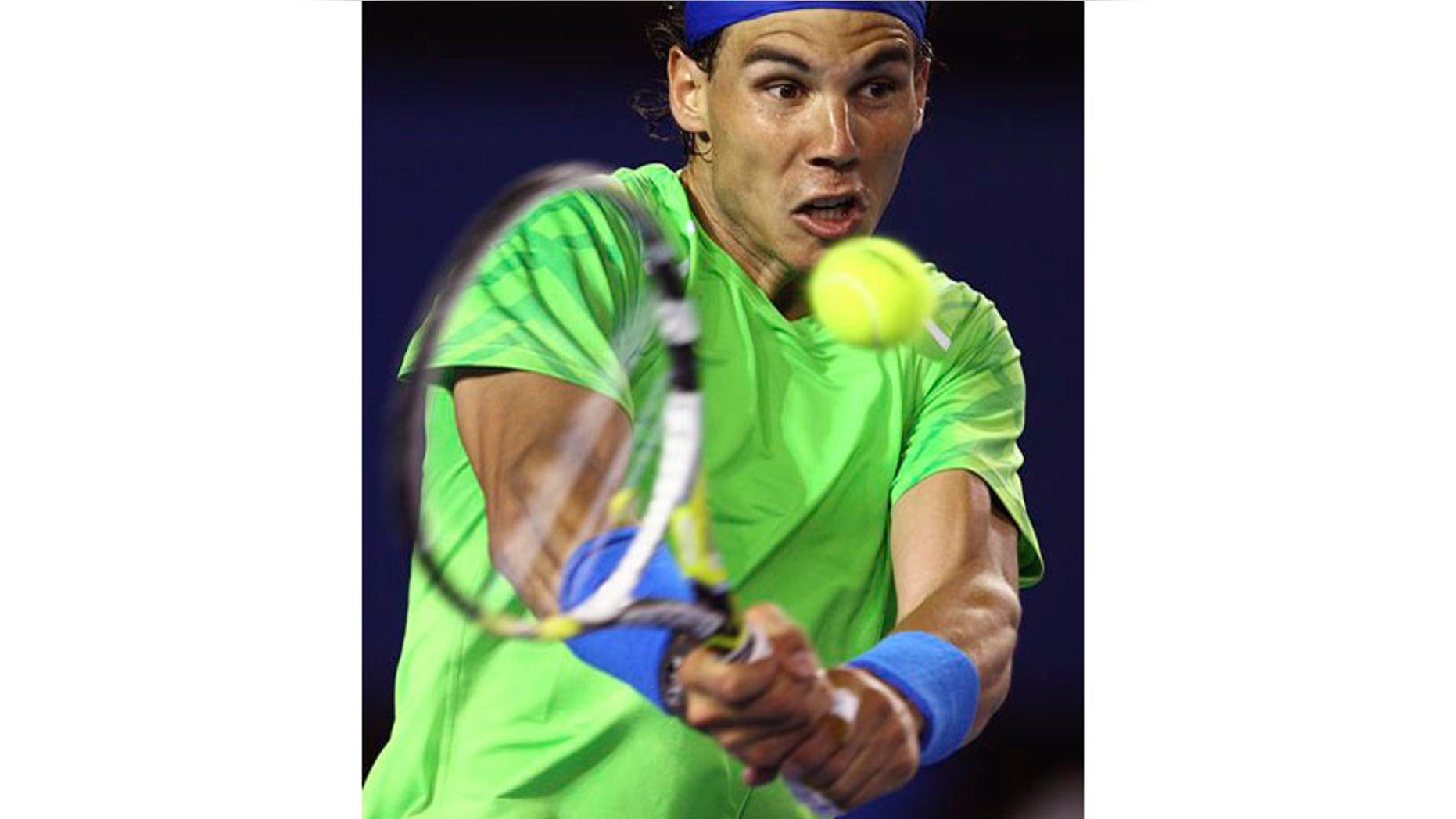 Rafael Nadal of Spain hits a backhand return to Tomas Berdych of the Czech Republic during their quarterfinal at the Australian Open tennis championship, in Melbourne, Australia, Tuesday, Jan. 24, 2012.(AP Photo/Rick Rycroft)
