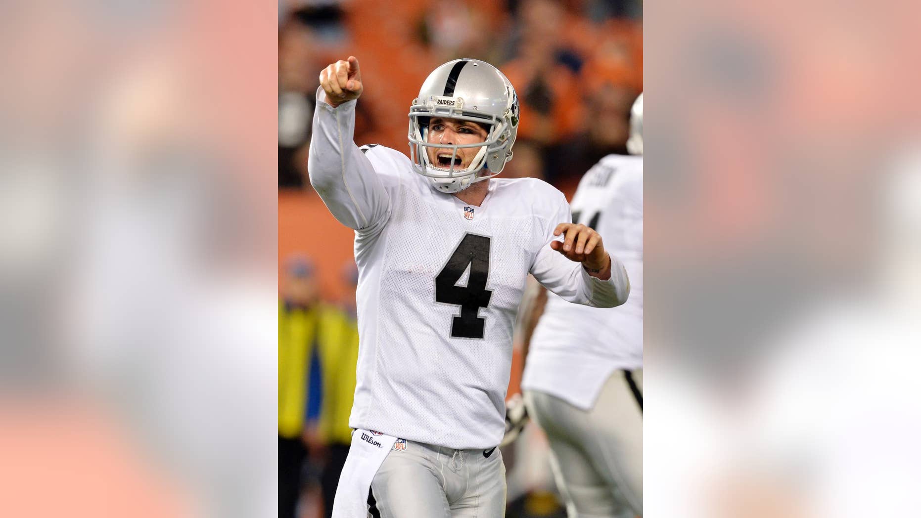 Oakland Raiders quarterback Derek Carr reacts after throwing a touchdown pass to wide receiver Andre Holmes in the fourth quarter of an NFL football game against the Cleveland Browns, Sunday, Oct. 26, 2014, in Cleveland. (AP Photo/David Richard)