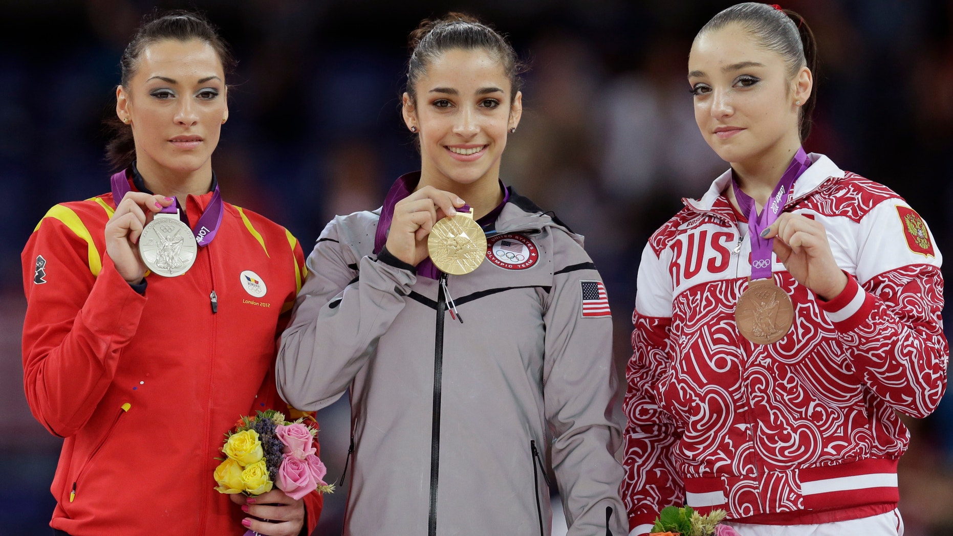 Aug. 7, 2012: U.S. gold medallist gymnast Alexandra Raisman, center, Romania's silver medallist Catalina Ponor, left, and bronze medallist Russia's Aliya Mustafina display their medals during the podium ceremony for the artistic gymnastics women's floor exercise final at the 2012 Summer Olympics.