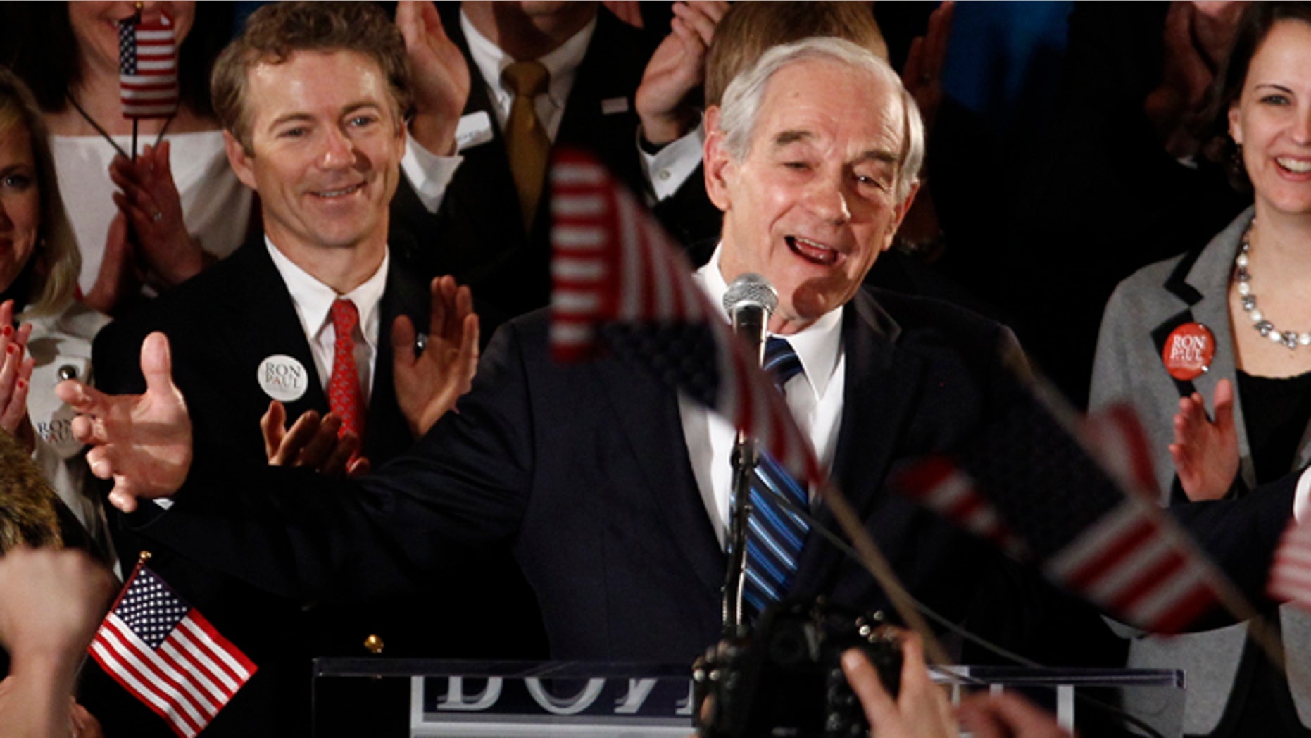 FILE: Jan. 3, 2012: Former GOP presidential candidate Texas Rep. Ron Paul and son Kentucky GOP Sen. Rand Paul at a rally in Ankeny, Iowa.