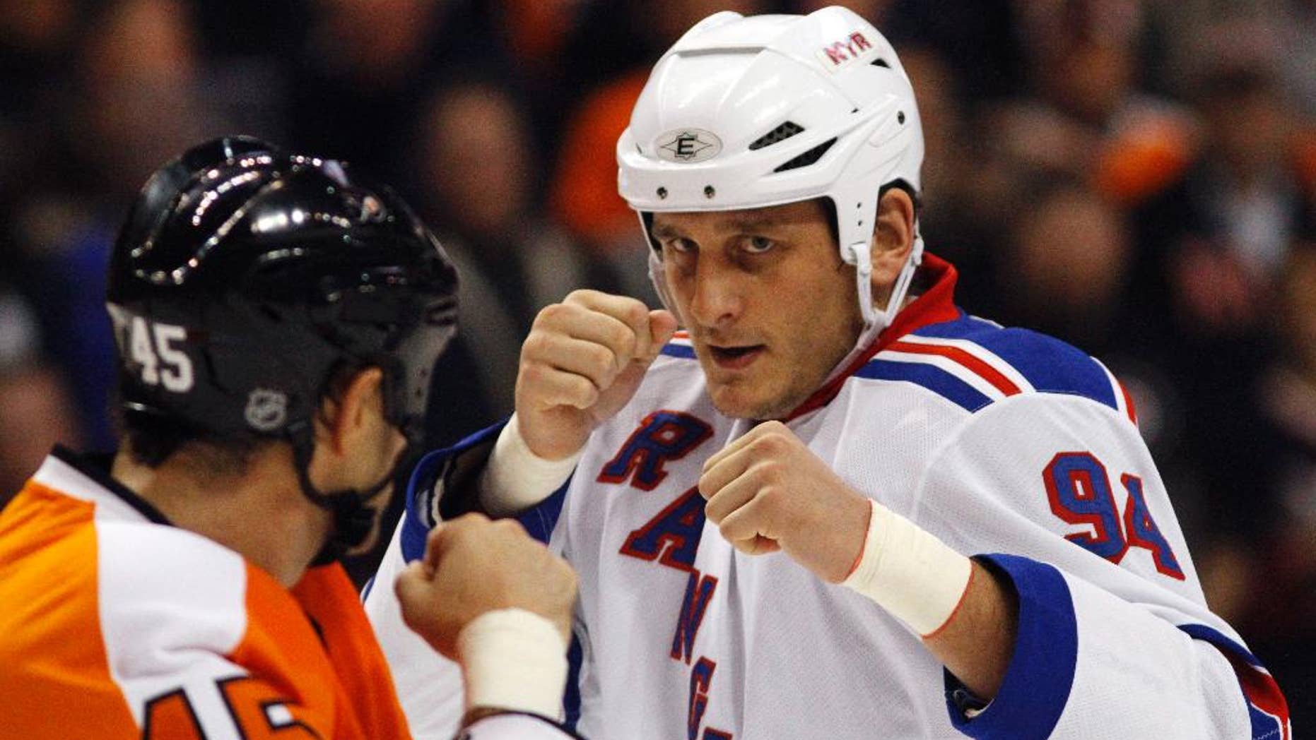 FILE - In this Nov. 4, 2010, file photo, Philadelphia Flyers' Jody Shelley, left, and New York Rangers' Derek Boogaard fight during an NHL hockey game in Philadelphia. A former minor league hockey player has been arrested on charges he sold illegally obtained prescription painkillers to former hockey player Derek Boogaard of the Rangers and the Minnesota Wild who died of an accidental overdose. Jordan Hart was arrested Tuesday, Sept. 9, 2014, on charges in a federal indictment unsealed in New York. (AP Photo/Matt Slocum, File)