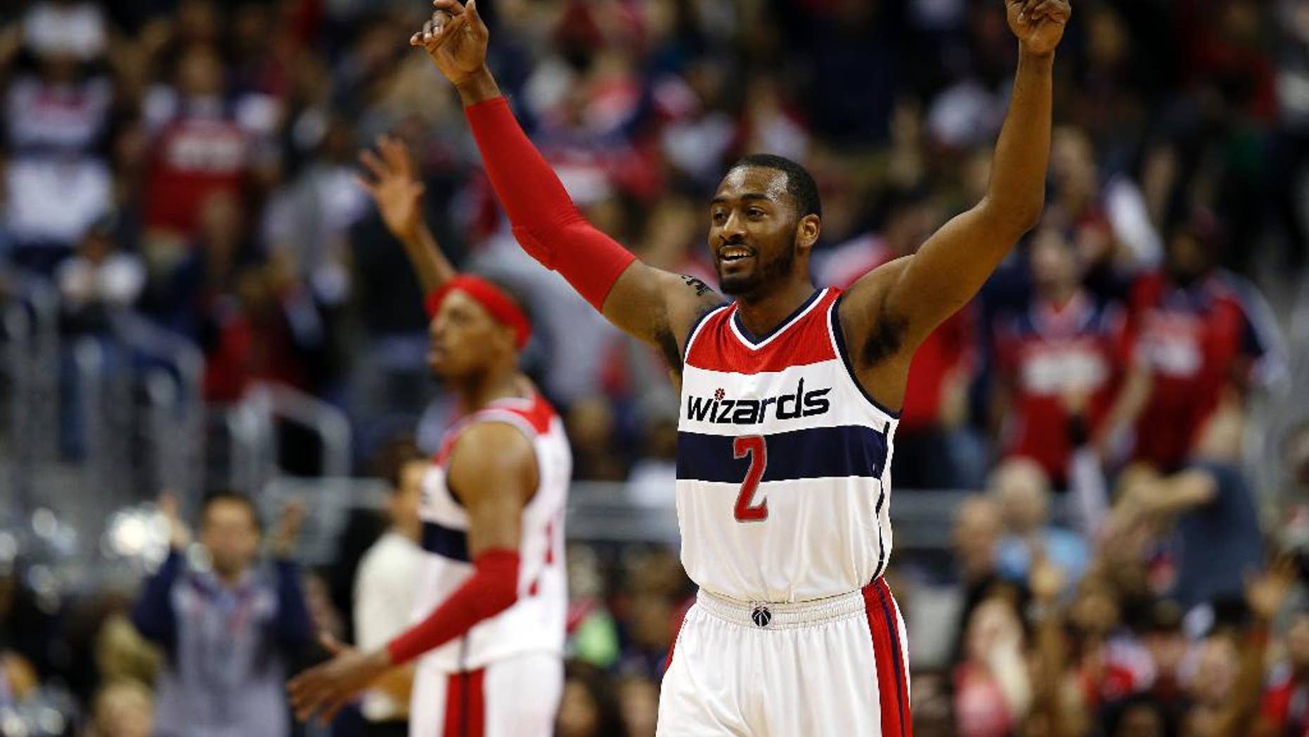 Washington Wizards guard John Wall (2) celebrates with forward Paul Pierce, behind, in the second half of Game 4 in the first round of the NBA basketball playoffs against the Toronto Raptors, Sunday, April 26, 2015, in Washington. The Wizards won 125-94 to complete the first sweep of a seven-game series in club history, and advancing them to the second-round. (AP Photo/Alex Brandon)