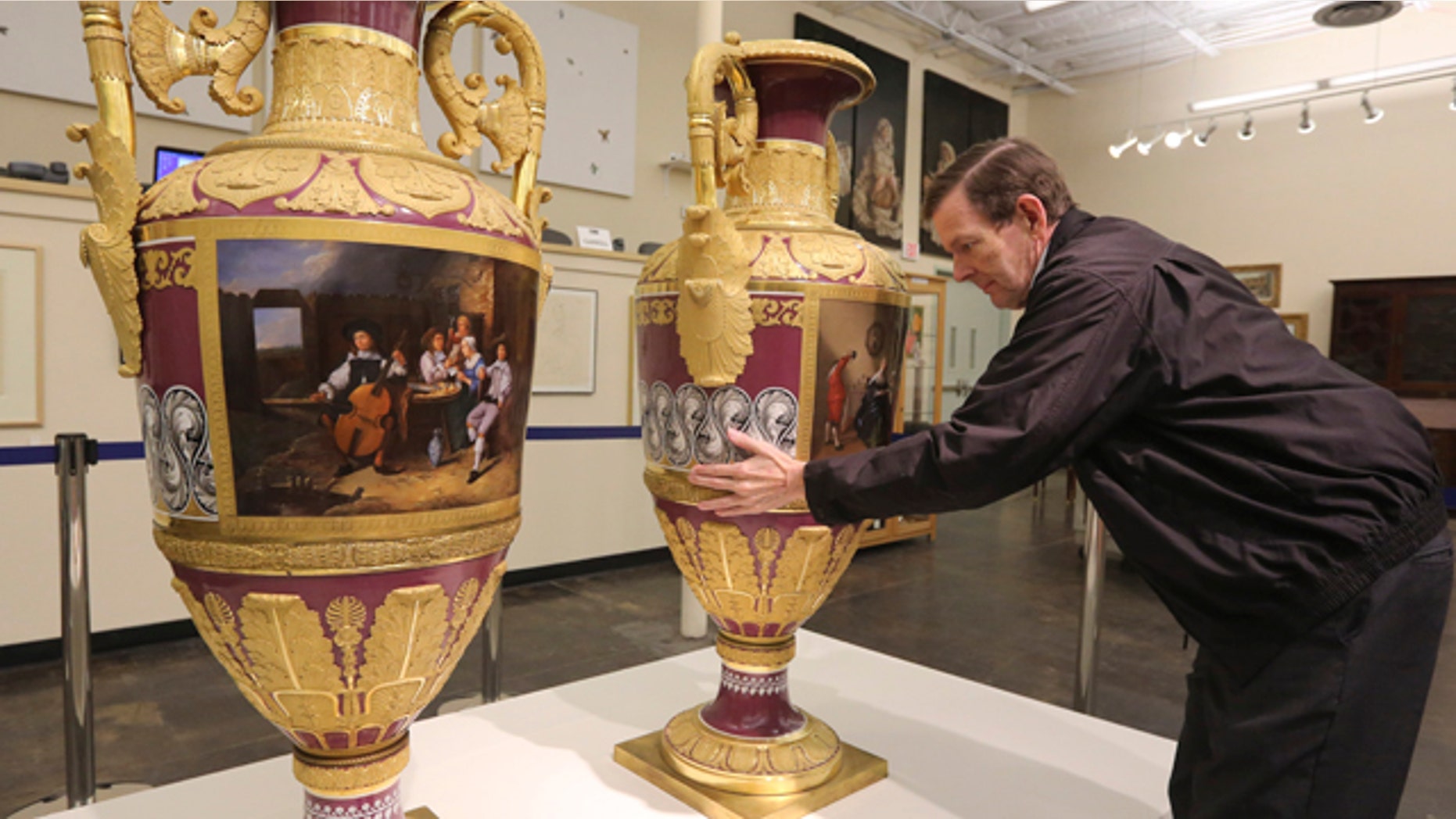 April 4, 2013: Jerry Holley, executive vice president of Dallas Auction Gallery, rotates a rare Russian vases made in 1833 by Russia's Imperial Porcelain Factory and on display at the gallery in Dallas.