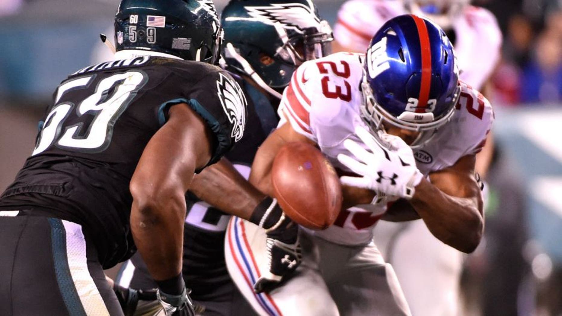 Oct 19, 2015; Philadelphia, PA, USA; New York Giants running back Rashad Jennings (23) fumbles the football while being hit by Philadelphia Eagles free safety Malcolm Jenkins (27) during the second quarter at Lincoln Financial Field. Mandatory Credit: Eric Hartline-USA TODAY Sports