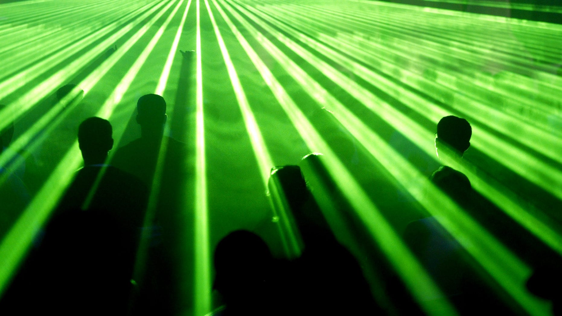 People dance during a rave party at Skolbeat Festival at Sambodrome, in Sao Paulo, April 24, 2004. More than 30,000 people took part in the Skolbeat Festival, with 57 DJ's playing techno music during all night in five stages.