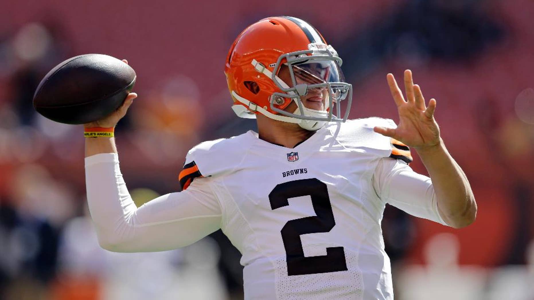 Cleveland Browns quarterback Johnny Manziel warms up before an NFL football game against the Baltimore Ravens, Sunday, Sept. 21, 2014, in Cleveland. (AP Photo/Tony Dejak)