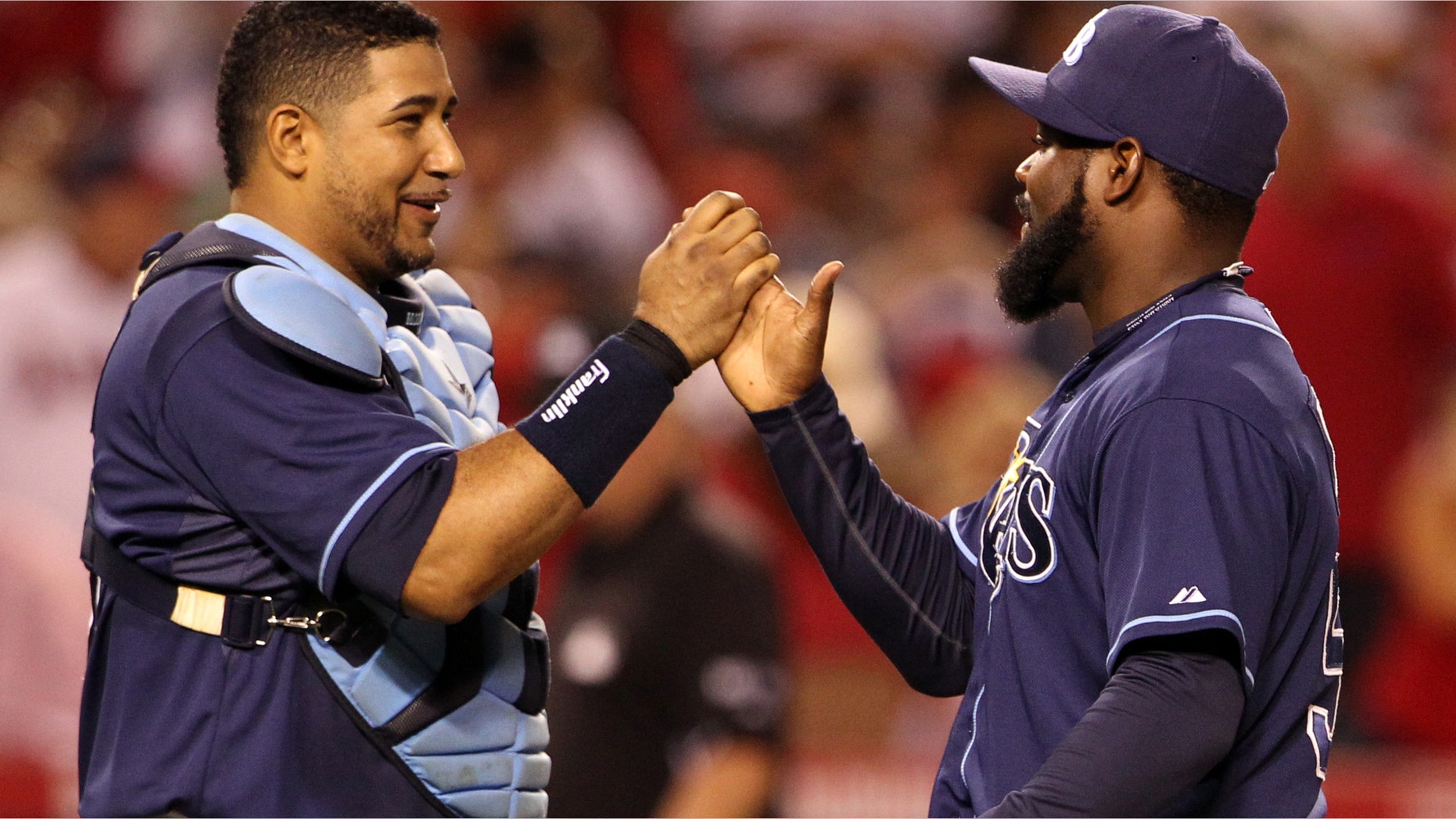 Tampa Bay Rays catcher Jose Molina, left, and reliever Fernando Rodney celebrate their 3-0 win over the Los Angeles Angels in a baseball game in Anaheim, Calif., Saturday, July 28, 2012. (AP Photo/Reed Saxon)