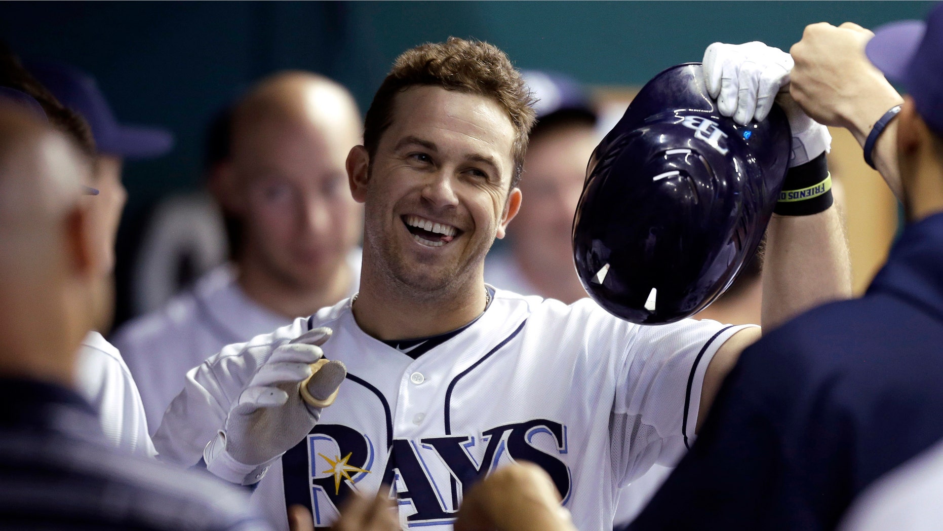 This Oct. 3, 2012 file photo shows Tampa Bay Rays' Evan Longoria celebrating with teammates in the dugout after his sixth-inning home run off Baltimore Orioles relief pitcher Jake Arrieta during a baseball game in St. Petersburg, Fla. (AP Photo/Chris O'Meara, File)