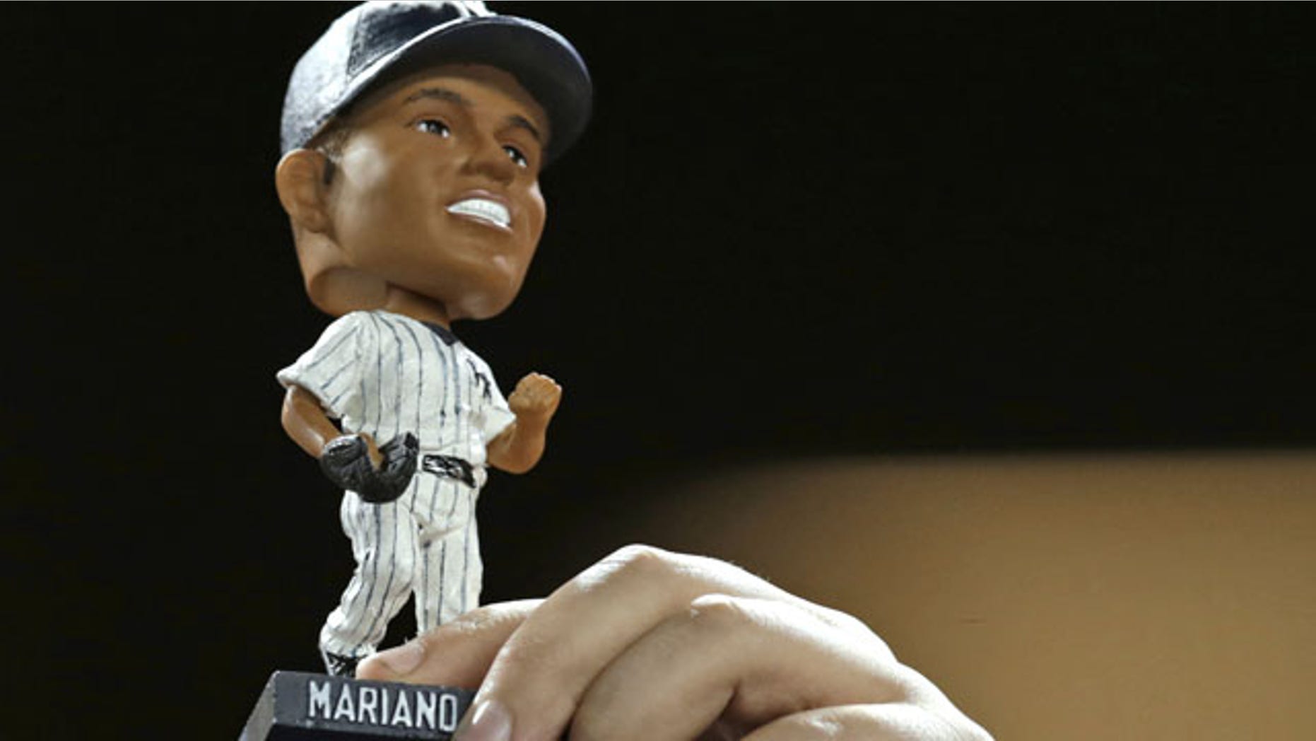 September 24, 2013: A fan holds up a Mariano Rivera bobblehead doll during the New York Yankees' baseball game against the Tampa Bay Rays Tuesday in New York. (AP Photo/Kathy Willens)
