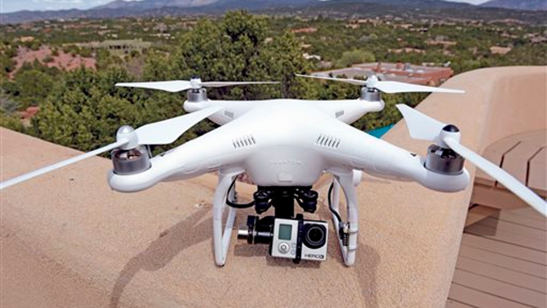 The remote controlled DJI Phantom drone with an attached GoPro 3 camera used by Brian Tercero of Keller Williams Realty used to create a high definition video of a property is seen in Santa Fe, N.M. on April 18, 2014. (AP Photo/The Santa Fe New Mexican, Clyde Mueller)