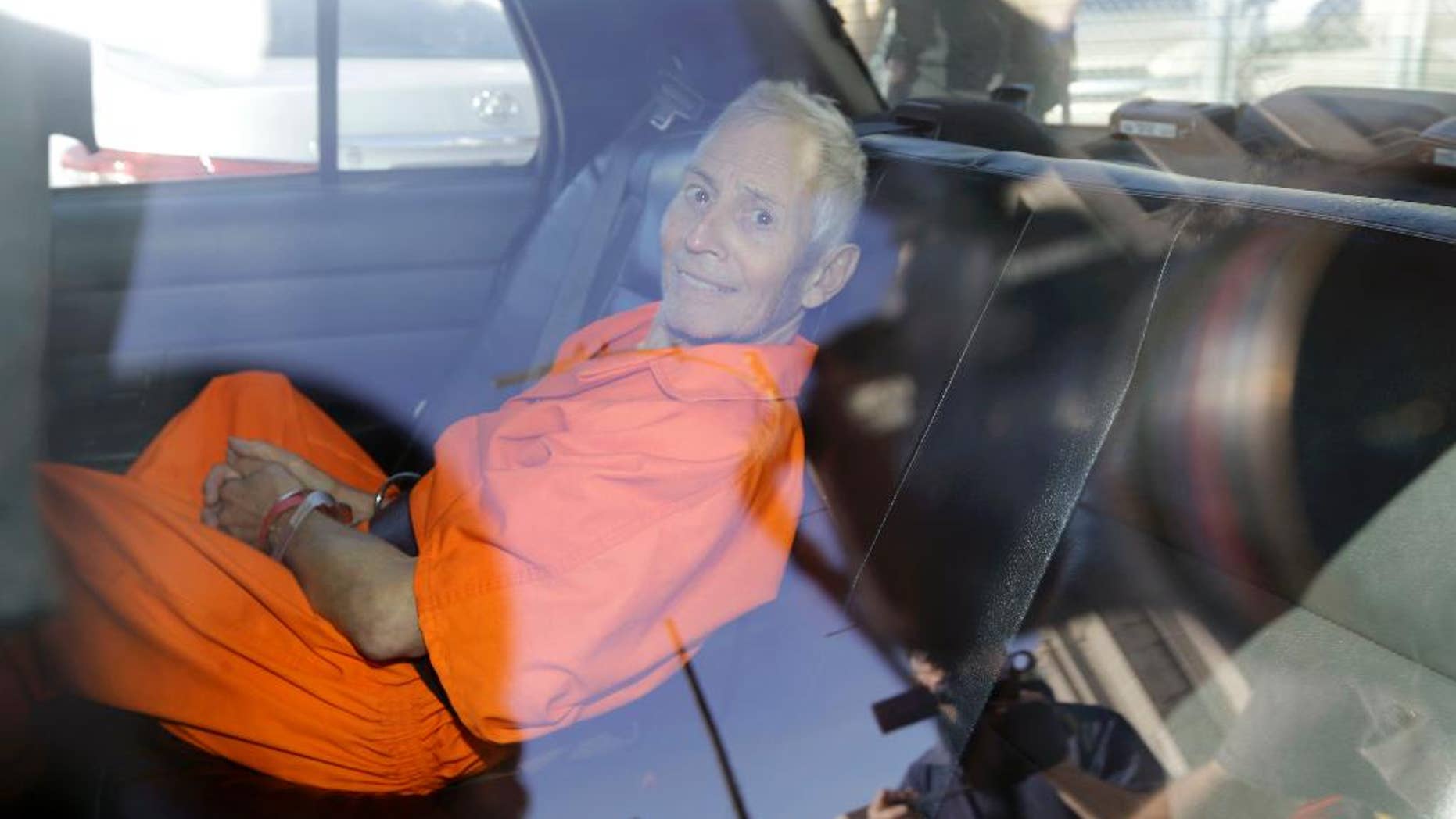 FILE - In this March 2015, file photo, Robert Durst is transported from Orleans Parish Criminal District Court to the Orleans Parish Prison after his arraignment in New Orleans. Durst was indicted Wednesday, April 8, on the two weapons charges that have kept him in New Orleans even though his lawyers say he wants to go to Los Angeles as soon as possible to face a murder charge. (AP Photo/Gerald Herbert, File)