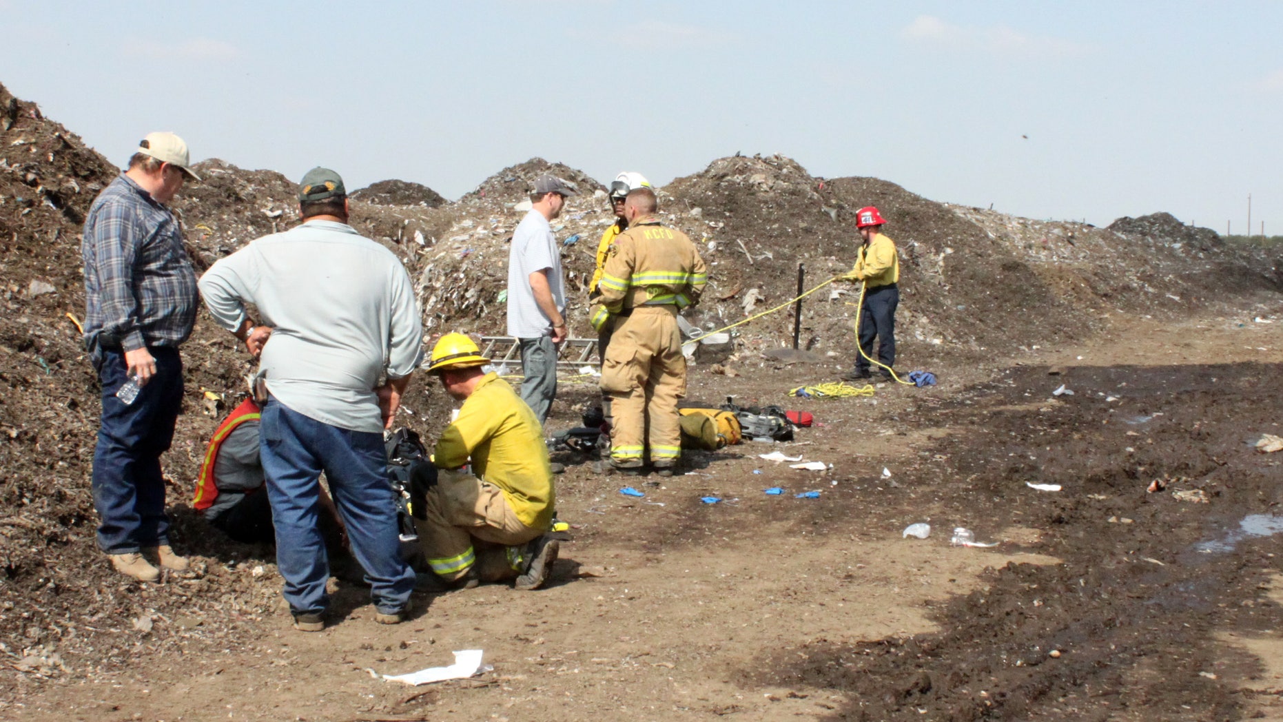 This image provided by the Kern County Sheriff's Department shows rescue personnel at the scene where a teenager was killed and his brother was critically injured in Lamont, Calif., when they were overcome by fumes in a tunnel at the recycling plant where they worked, Kern County officials said Friday Oct.14, 2011. (AP Photo/Kern County (Calif.) Sheriff's Department)