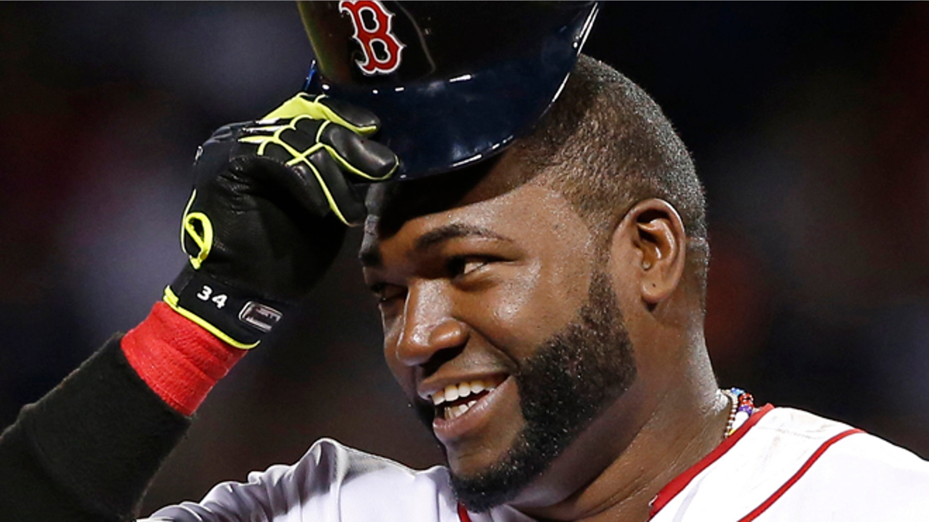 Aug. 20, 201: Boston Red Sox designated hitter David Ortiz tips his cap while standing on third base during a baseball game.