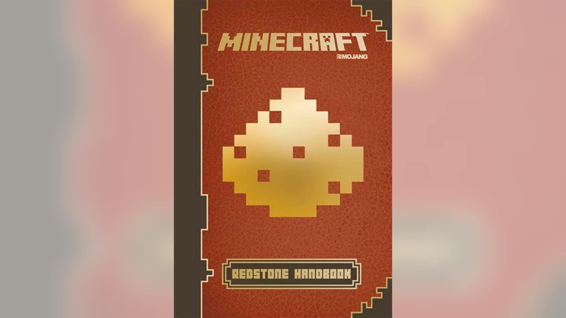 This photo provided by Scholastic shows the cover of the book, "Minecraft: Essential Handbook."