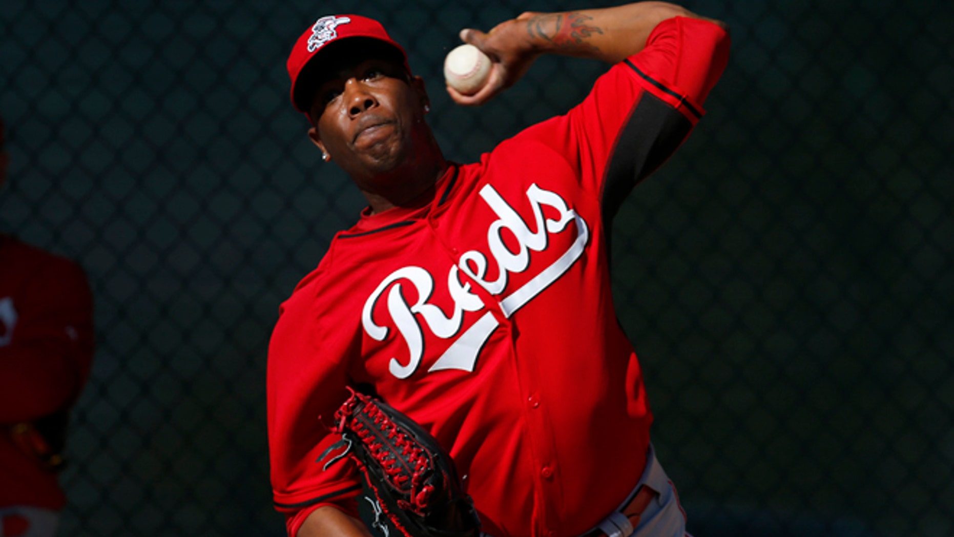 FILE - In this Feb. 15, 2014, file photo, Cincinnati Reds relief pitcher Aroldis Chapman throws during spring training baseball practice in Goodyear, Ariz. Chapman, with two black eyes, has returned to the Reds' clubhouse four days after being hit in the face by a line drive. The 26-year old left-hander had surgery at Banner Good Samaritan Medical Center, Thursday, March 20, 2014, to repair a broken bone above his left eye. (AP Photo/Paul Sancya, File)
