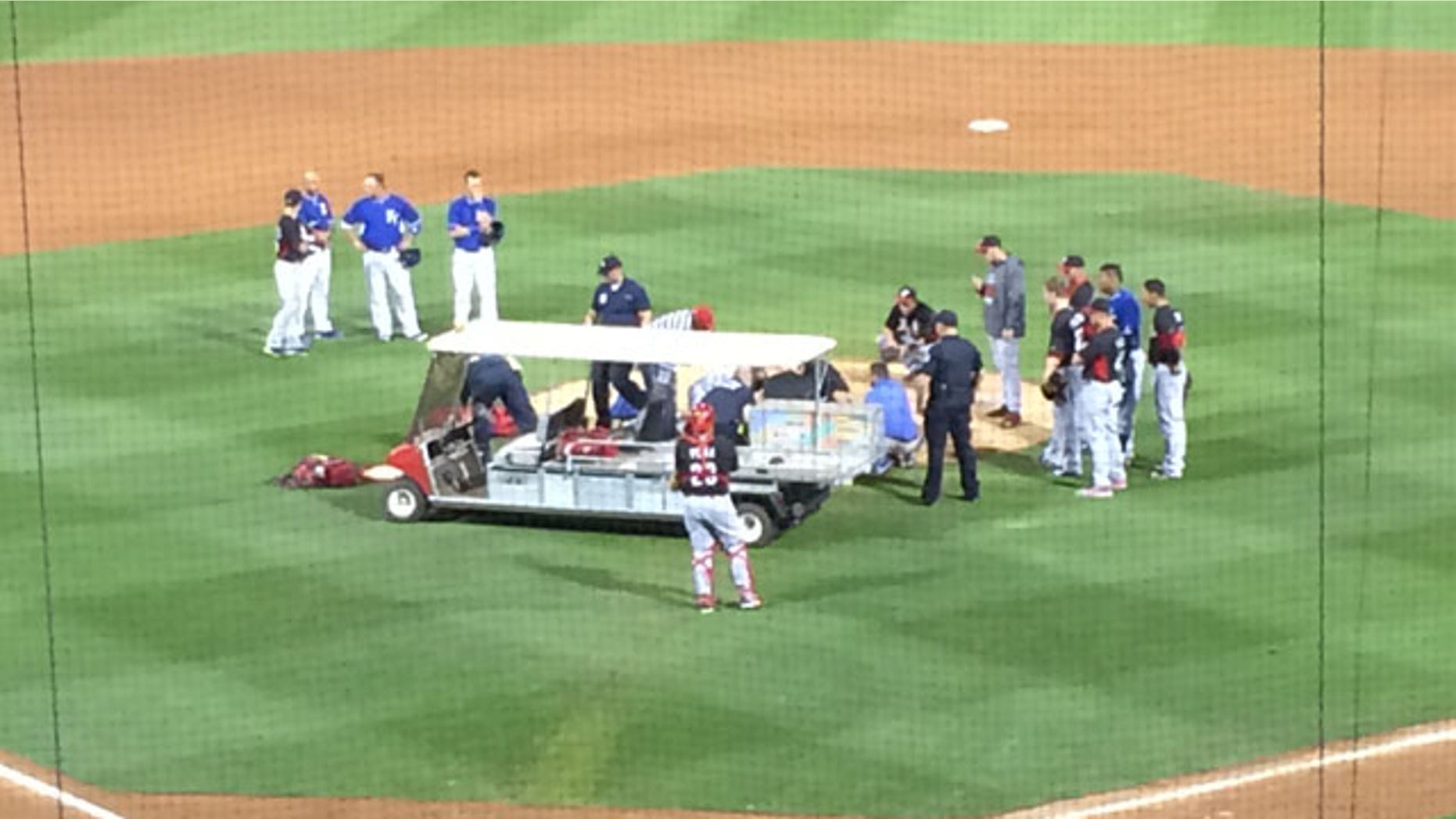 March 19, 2014: In this image provided by Mark Sheldon Cincinnati Reds closer Aroldis Chapman is taken off the field after being hit by a line drive. Chapman broke bones above his left eye and nose. (AP Photo/Mark Sheldon)
