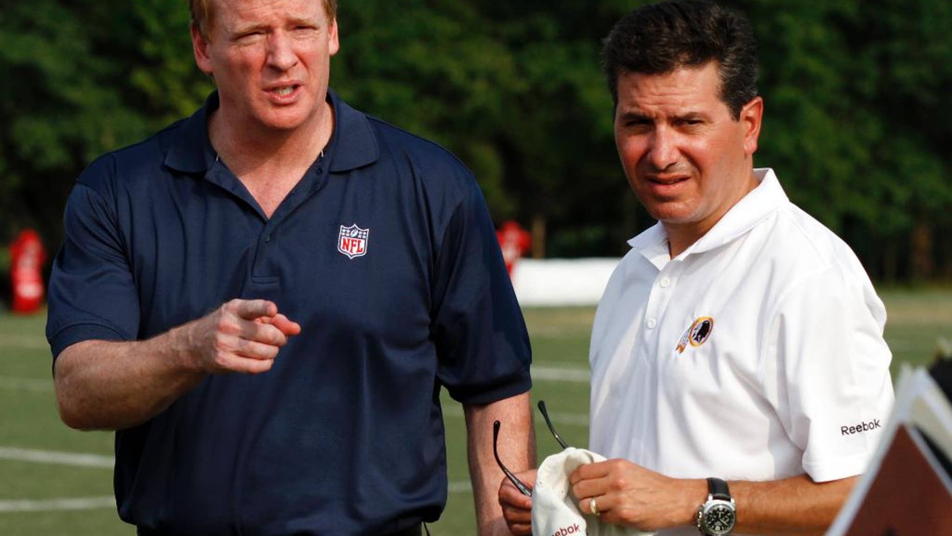 FILE - In this Aug. 4, 2010, file photo, NFL Commissioner Roger Goodell, left, talks with Washington Redskins owner Daniel Snyder, right, after the team's NFL football training camp at Redskins Park in Ashburn, Va. In a statement released Saturday, Sept. 13, 2014, Snyder says he supports Goodell, stating he "has always had the best interests of football at heart" and "we are fortunate to have him." (AP Photo/Rob Carr, File)