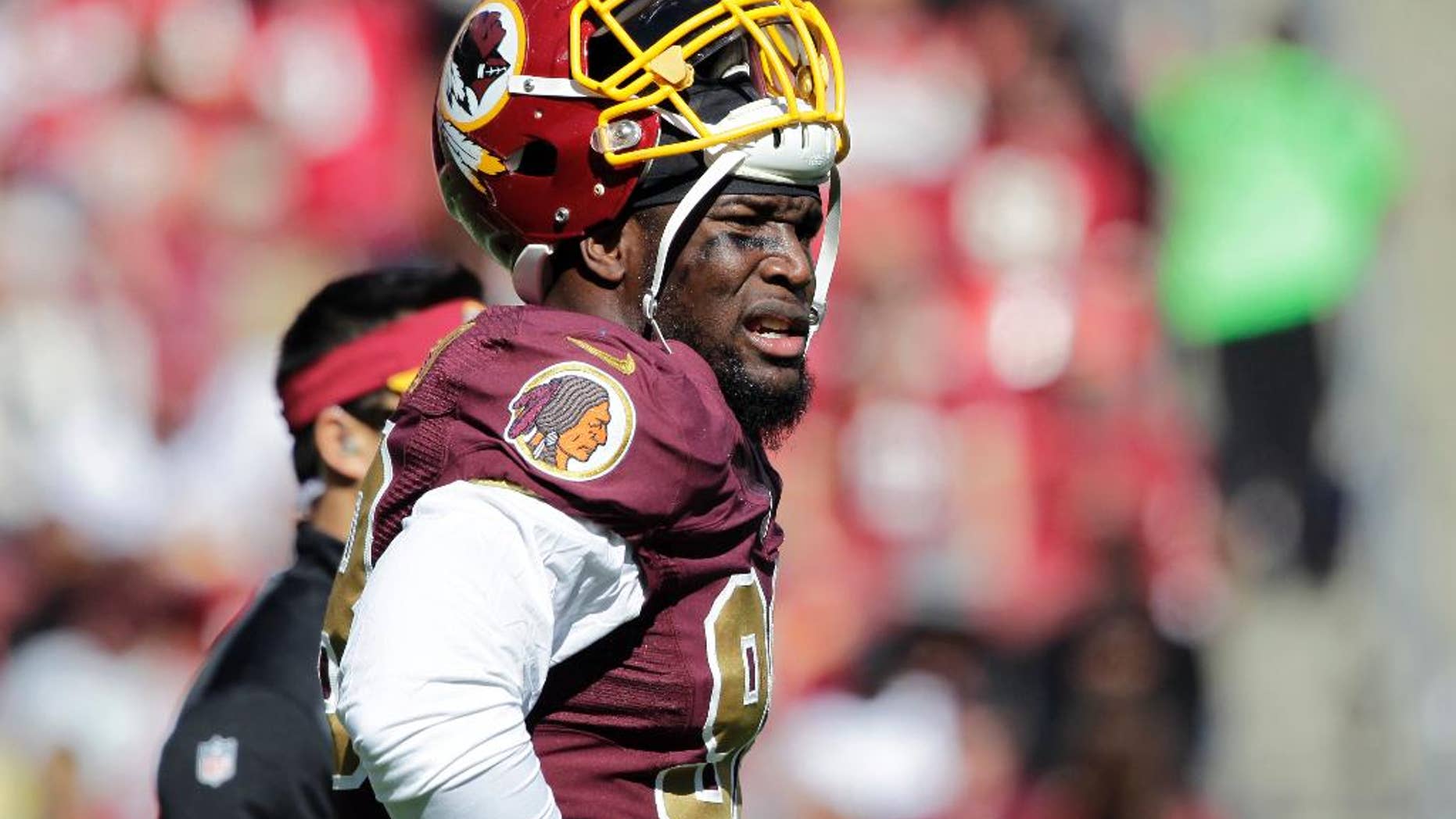 FILE - In this Oct. 19, 2014, file photo, Washington Redskins outside linebacker Brian Orakpo (98) pauses on the field during the first half of an NFL football game against the Tennessee Titans in Landover, Md. Redskins coach Jay Gruden says linebacker Brian Orakpo is done for the season because of a torn right pectoral muscle. Gruden says Monday, Oct. 20, 2014, that Orakpo needs surgery. (AP Photo/Mark E. Tenally, File)