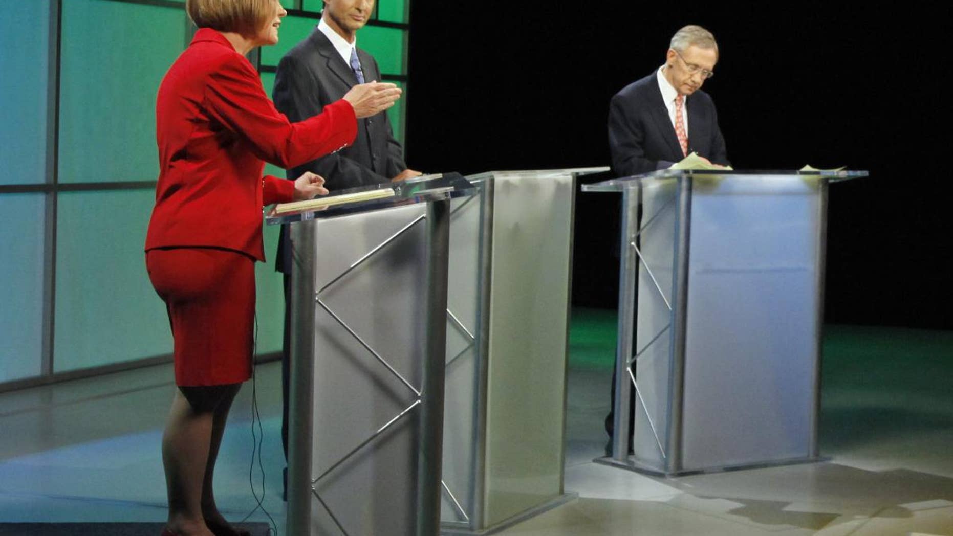 Republican Senate candidate Sharron Angle, left, speaks as moderator Mitch Fox, center, and Senate Majority Leader Harry Reid listen during a televised Nevada Senate debate Oct. 14, 2010, in Las Vegas. (AP Photo)