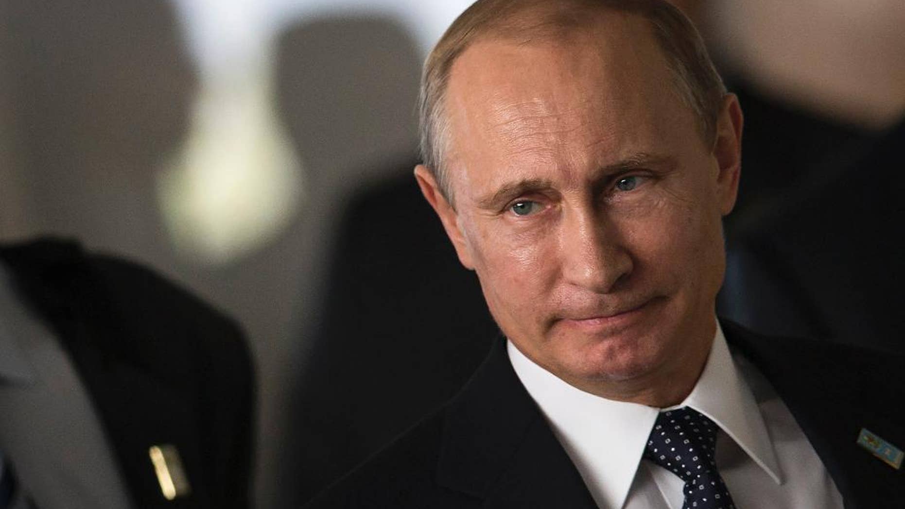 FILE - This, July 16, 2014, file photo shows Russia's President Vladimir Putin as he arrives for an official group photo during the BRICS summit at the Itamaraty palace, in Brasilia, Brazil. Months after Russia annexed Crimea and stepped up support for separatists in eastern Ukraine, Europe and the U.S. are still searching for an effective way to persuade Putin to change course. (AP Photo/Felipe Dana, File )