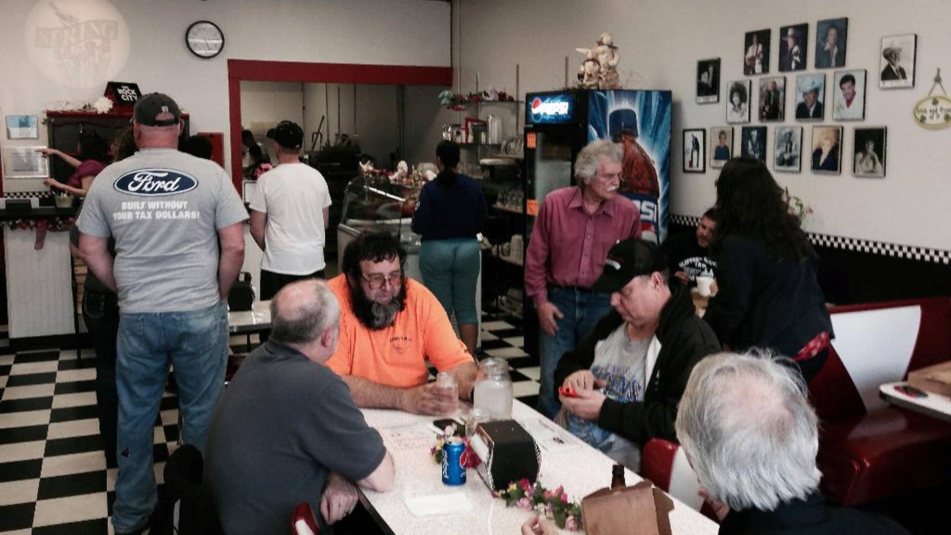 Many customers wait for service as Memories Pizza reopened for business Thursday, April, 9, 2015, in Walkerton, Ind. The restaurant was closed, and its operators said they'd gone into hiding after their comment that they would not serve pizza to a gay wedding prompted an avalanche of criticism on social media. Facing widespread pressure, including from big businesses, Indiana's Republican-controlled Legislature rolled back their states' new religious objections laws, which critics said could be used to discriminate against gays. (AP Photo/Tom Coyne)