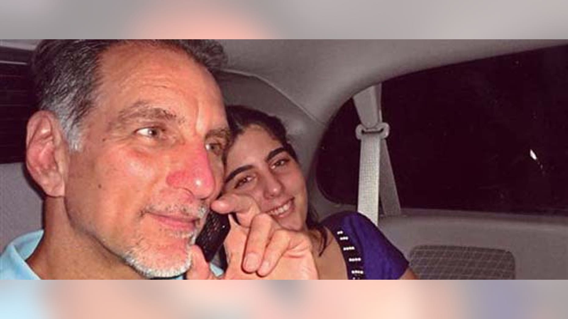 Oct. 12, 2011: In this photo released on Wednesday by the state media Cubadebate website, convicted Cuban agent René González talks on the phone accompanied by his youngest daughter Ivette, after he was freed from a Florida jail, after serving 13 years of a 15-year sentence, in Marianna, Fla.