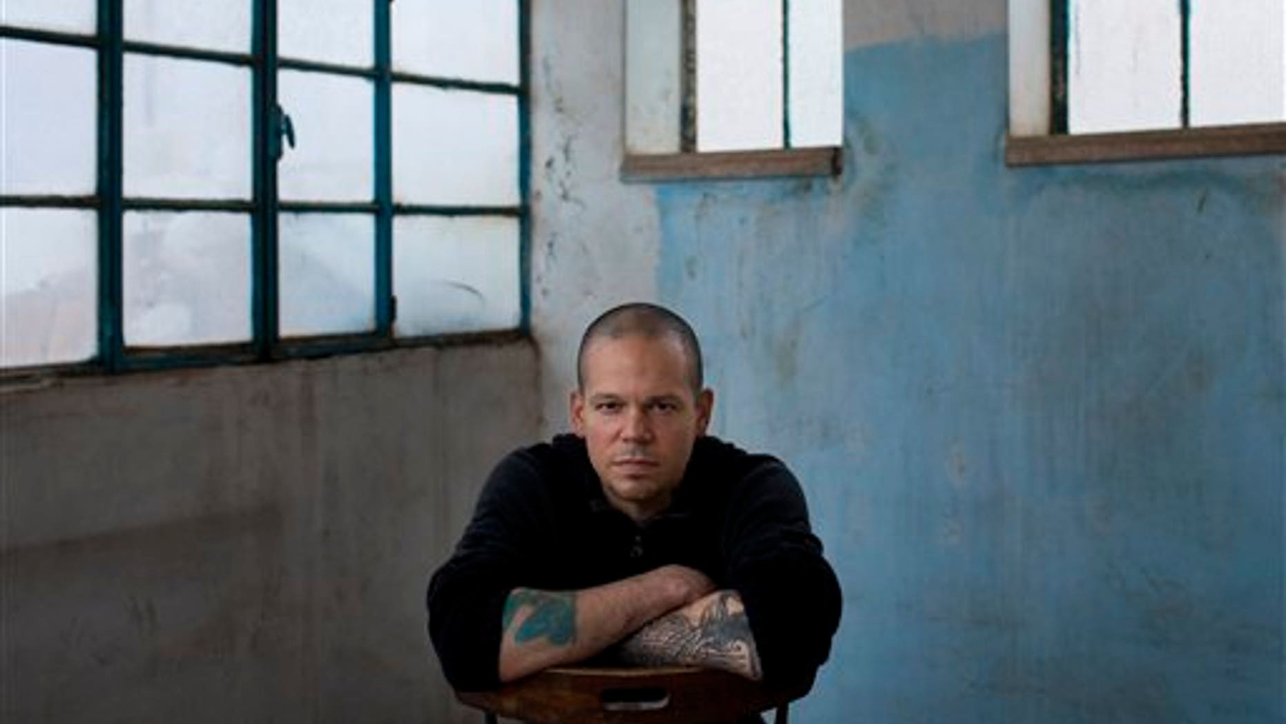 Rene Perez Joglar, also known as Residente, of Puerto Rico's musical group Calle 13, poses for a portrait after an interview with The Associated Press in the West Bank town of Beit Shaour, near Bethlehem, Thursday, Dec. 5, 2013. Perez has been in the West Bank filming Calle 13's next video called "Multi Viral." (AP Photo/Bernat Armangue)