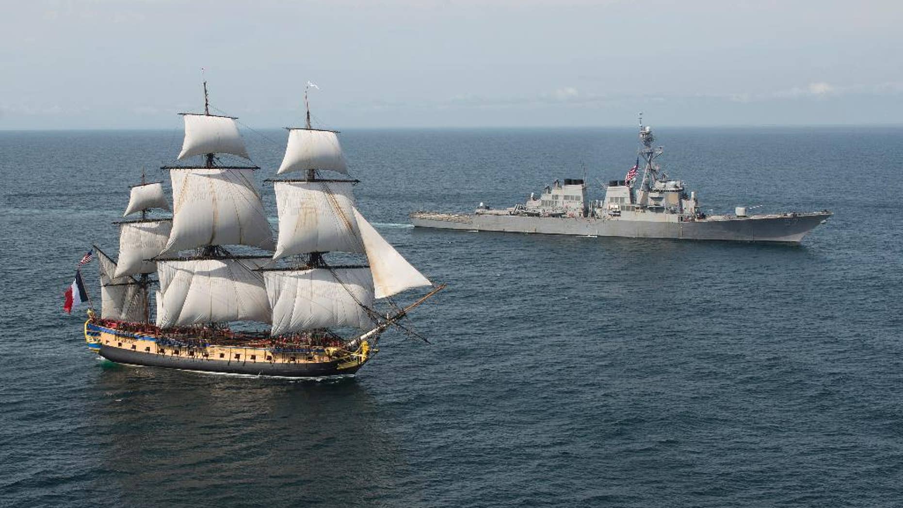 In this Tuesday, June 2, 2015 image provided by the U.S. Navy, the Arleigh Burke-class guided-missile destroyer USS Mitscher, right, welcomes the French tall ship replica Hermione in the vicinity of the Battle of Virginia Capes off the East Coast of the United States. The original Hermione brought French Gen. Marquis de Lafayette to America in 1780 to inform Continental Army Gen. George Washington that a French army was headed for America to assist in the war effort. The symbolic return of the Hermione will pay homage to Lafayette and the Franco-American alliance that brought victory at the Battle of Yorktown in 1781. The Hermione will visit Yorktown, Va., on June 5, and then continue up the Eastern Seaboard, visiting cities of Franco-American historical significance. (Petty Officer 1st Class Michael Sandberg/U.S. Navy via AP)