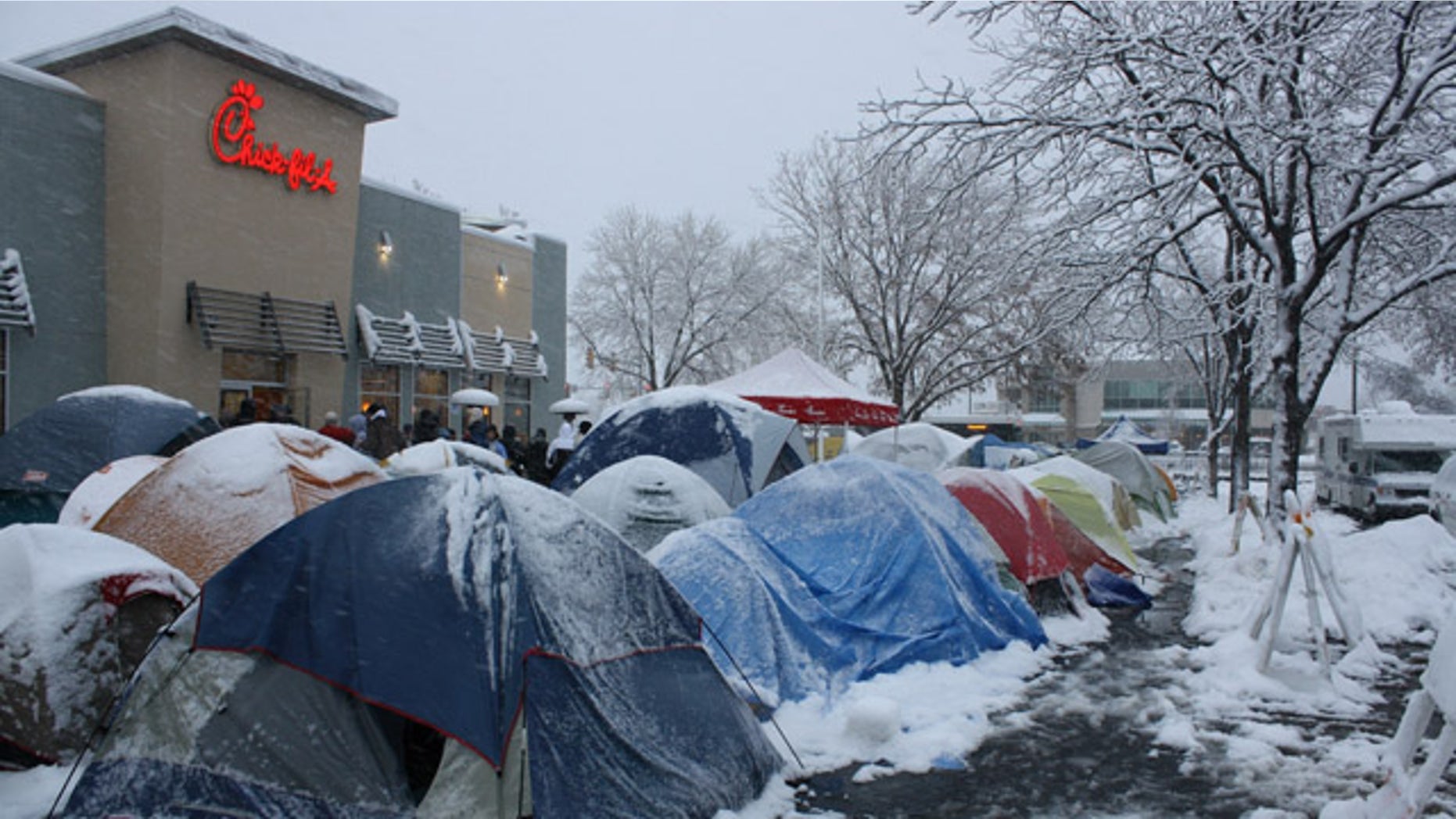 In this 2009 photo provided by Chick-fil-A, fans camp out in some extreme conditions, in Fort Collins, Colo., for the First 100 customers bonus coupons. Call it fanaticism or simply dedication, but these are the type of ultra-enthusiastic fans that every restaurant craves. (AP Photo/Chick-fil-A)