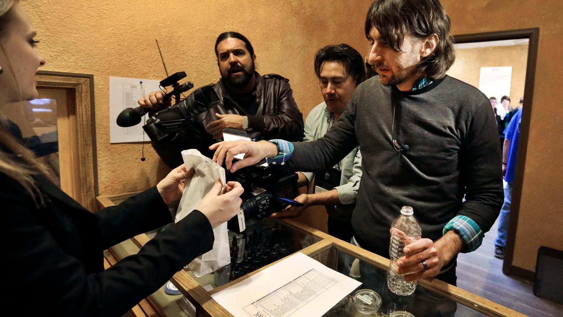 Adam Hartle is one of the first to buy marijuana at a legal recreational retail outlet in Denver, on Jan. 1, 2014.