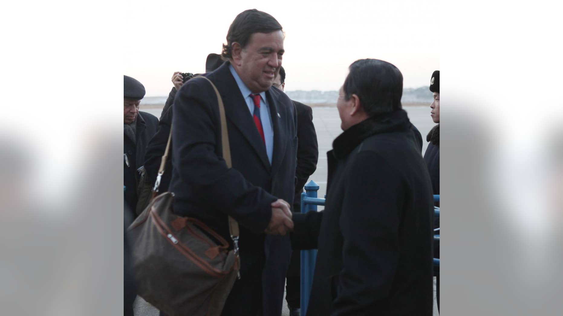 New Mexico Gov. Bill Richardson, left, is greeted by Li Gun, of the North Korean Foreign Ministry American Affairs Depertment, upon arriving at Pyongyang airport on Thursday Dec. 16, 2010. Richardson, who has frequently acted as an unofficial envoy to the North, arrived Thursday in Pyongyang after telling reporters in Beijing he expected to be given some sort of message by North Korea. (AP Photo/APTN)
