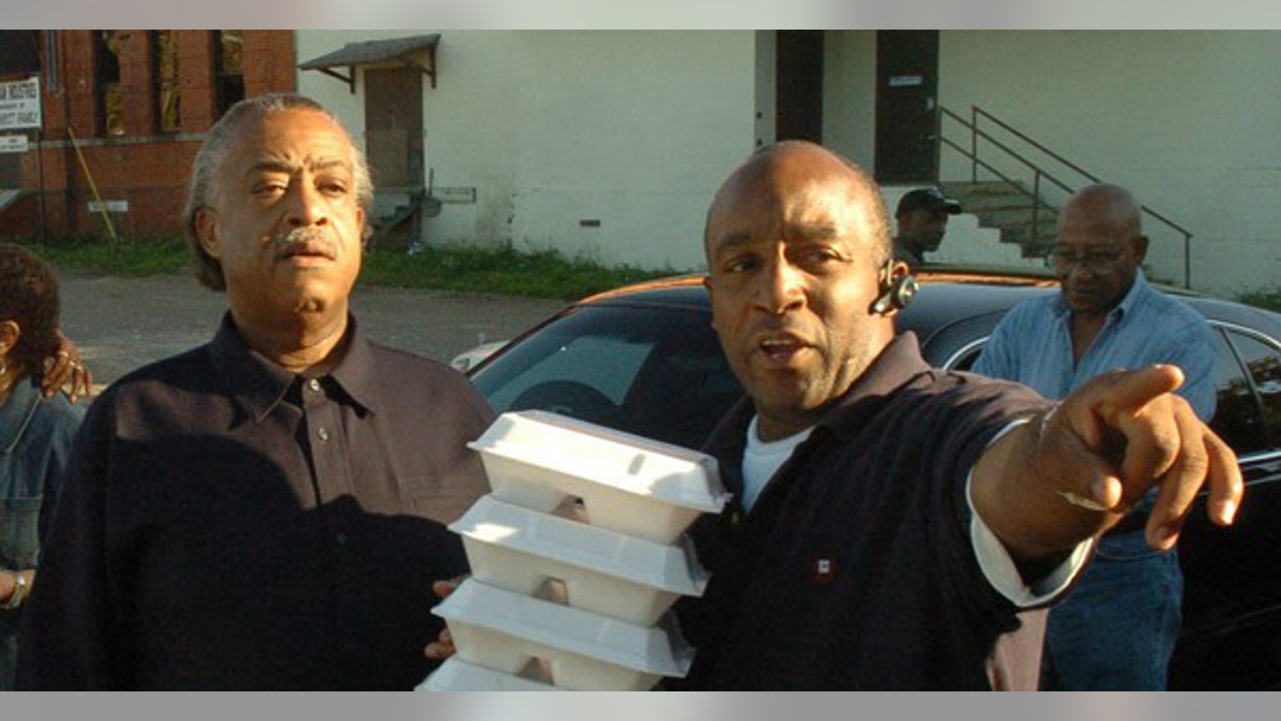 The Rev. Al Sharpton, left, is seen with Kenneth Glasgow, as they deliver holiday meals on Thanksgiving Day in 2006 in Dothan, Ala.