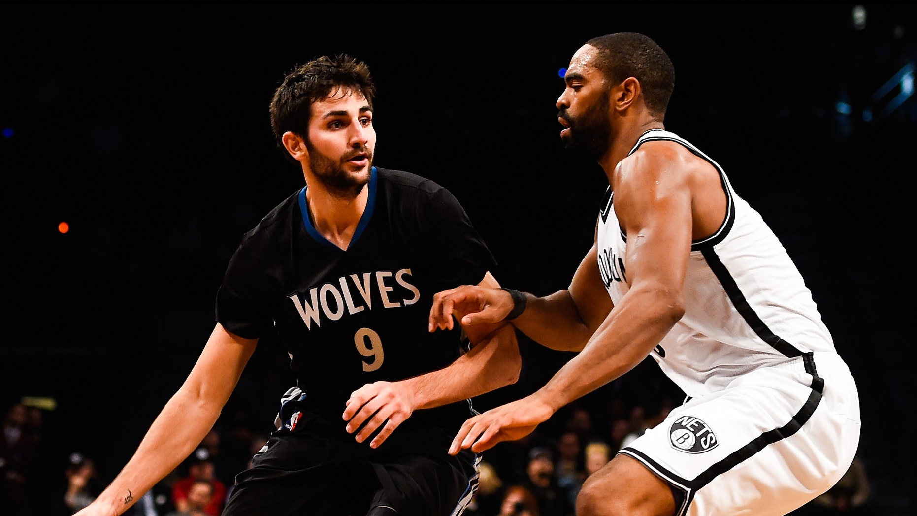 NEW YORK, NY - NOVEMBER 05: Ricky Rubio #9 of the Minnesota Timberwolves attempts to drive around Alan Anderson #6 of the Brooklyn Nets in the third quarter at the Barclays Center on November 5, 2014 in the Brooklyn borough of New York City. NOTE TO USER: User expressly acknowledges and agrees that, by downloading and/or using this photograph, user is consenting to the terms and conditions of the Getty Images License Agreement. (Photo by Alex Goodlett/Getty Images)