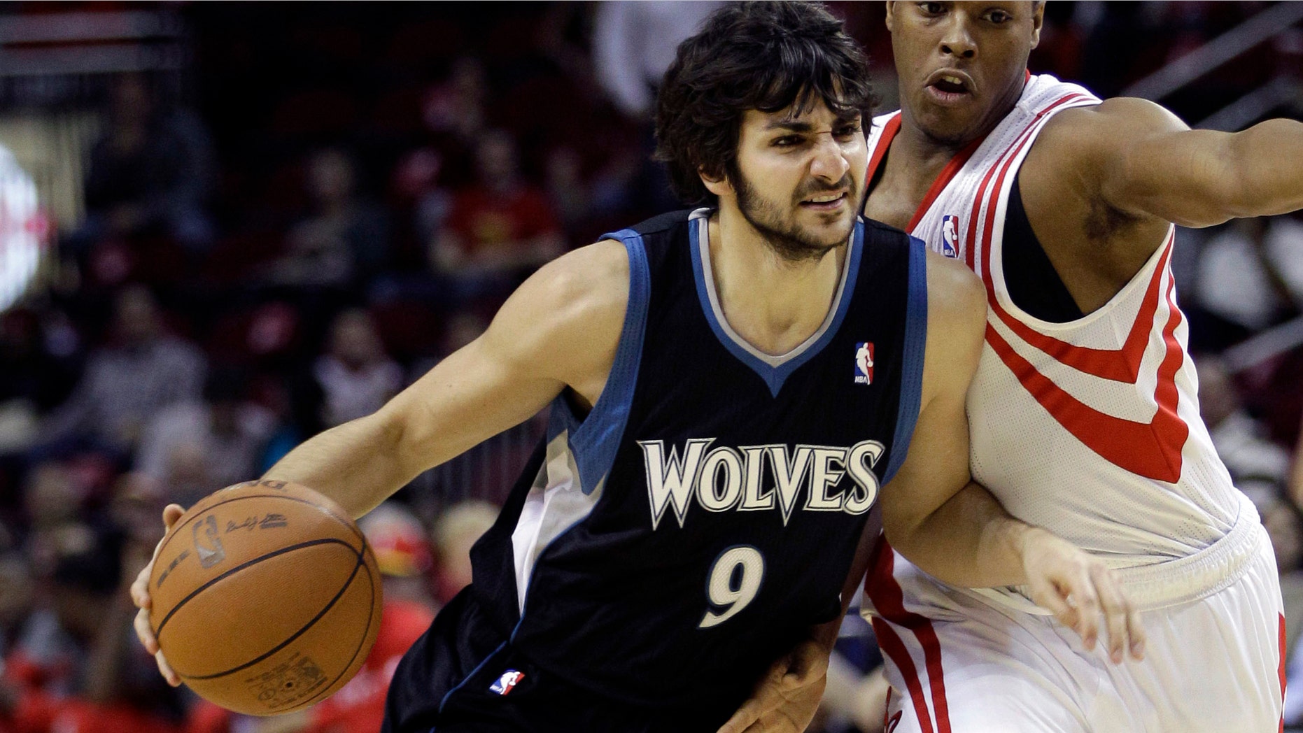 Minnesota Timberwolves' Ricky Rubio drives toward the basket as Houston Rockets' Kyle Lowry, right, defends during the first quarter of an NBA basketball game on Friday in Houston. (AP Photo/David J. Phillip)